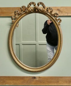 Oval Wall Hanging Gilt Mirror Decorated with Ribbons  A lovely piece