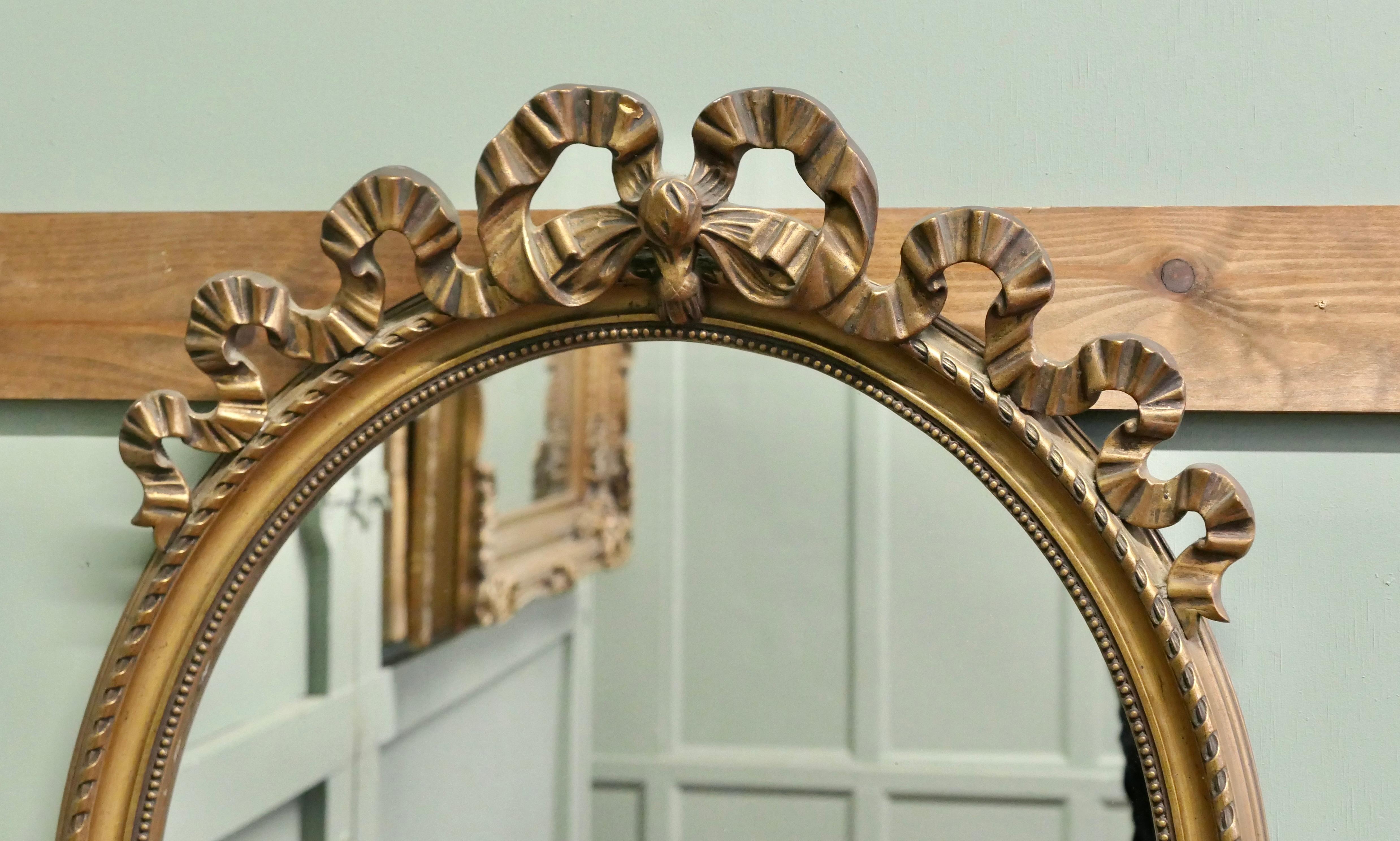 Specchio ovale da parete dorato e decorato con nastri  Un pezzo incantevole In condizioni buone in vendita a Godshill, Isle of Wight