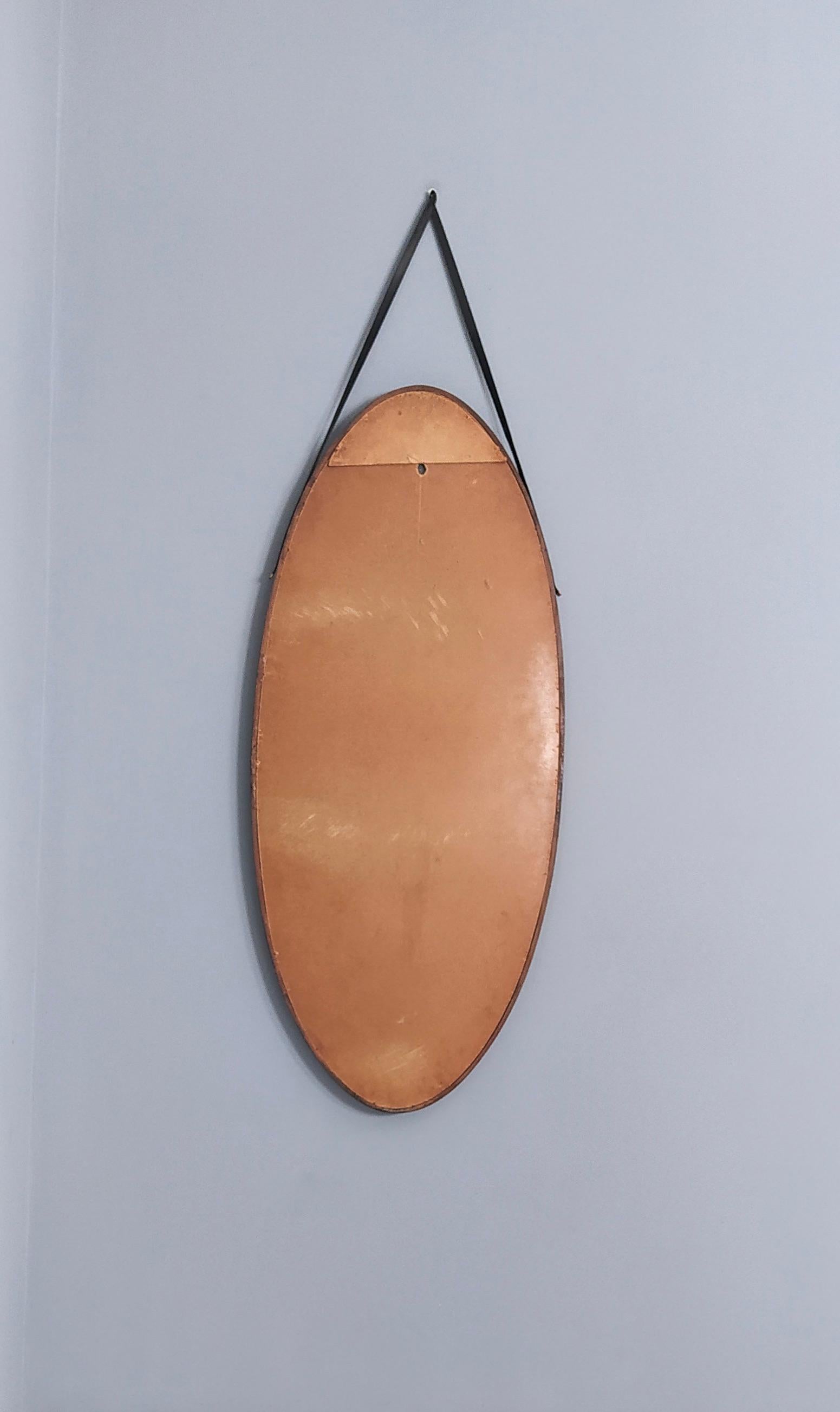 Mid-20th Century Oval Vintage Wall Mirror with Ebonized Wood Frame and a Leather Hook, Italy
