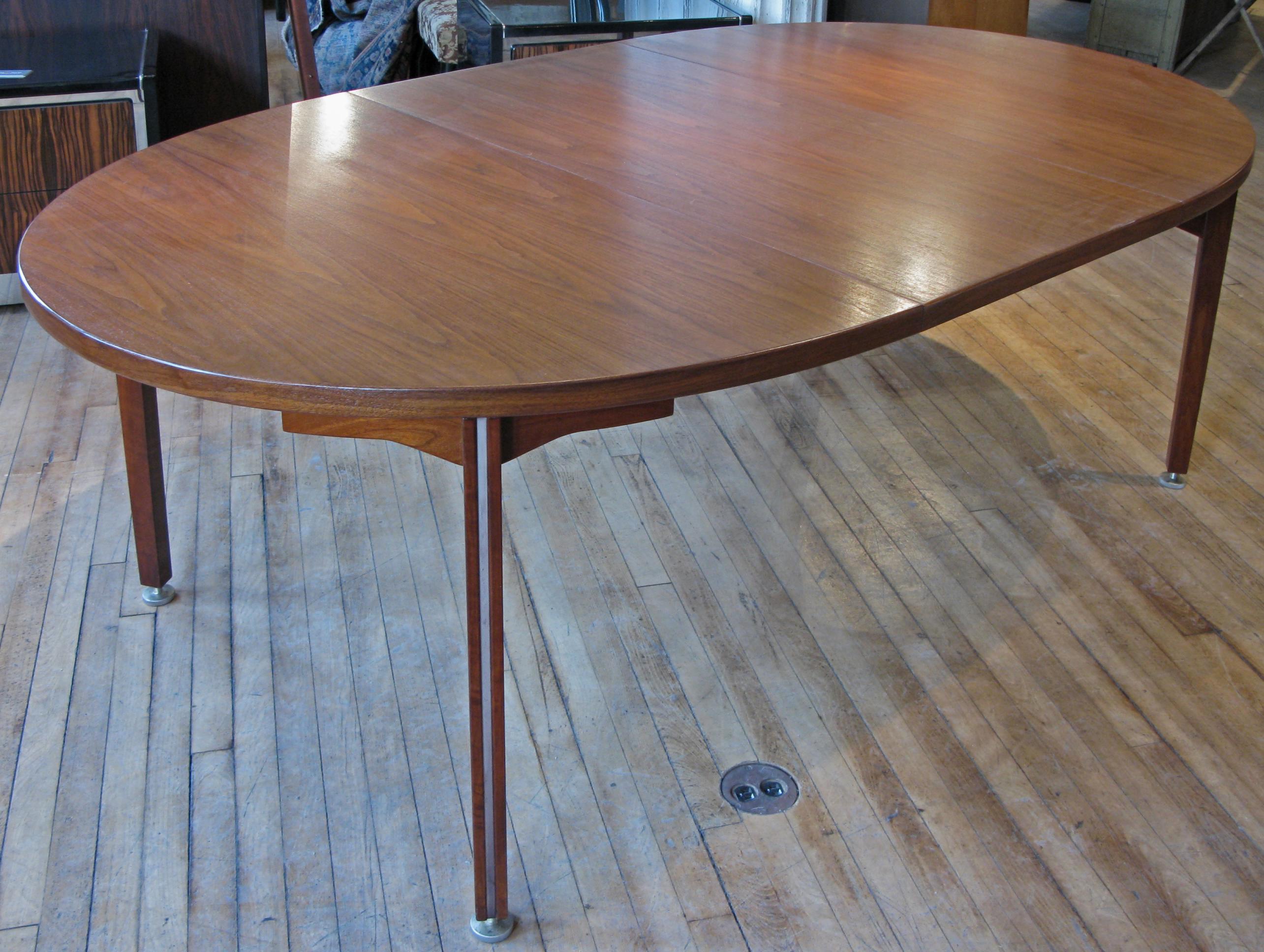 Vintage 1960s walnut dining table by Jens Risom. Dimension (with out Leaves) is 60 x 48. With addition of each 24