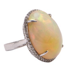 Oval White Opal and Diamond Halo Ring in 18 Carat White Gold