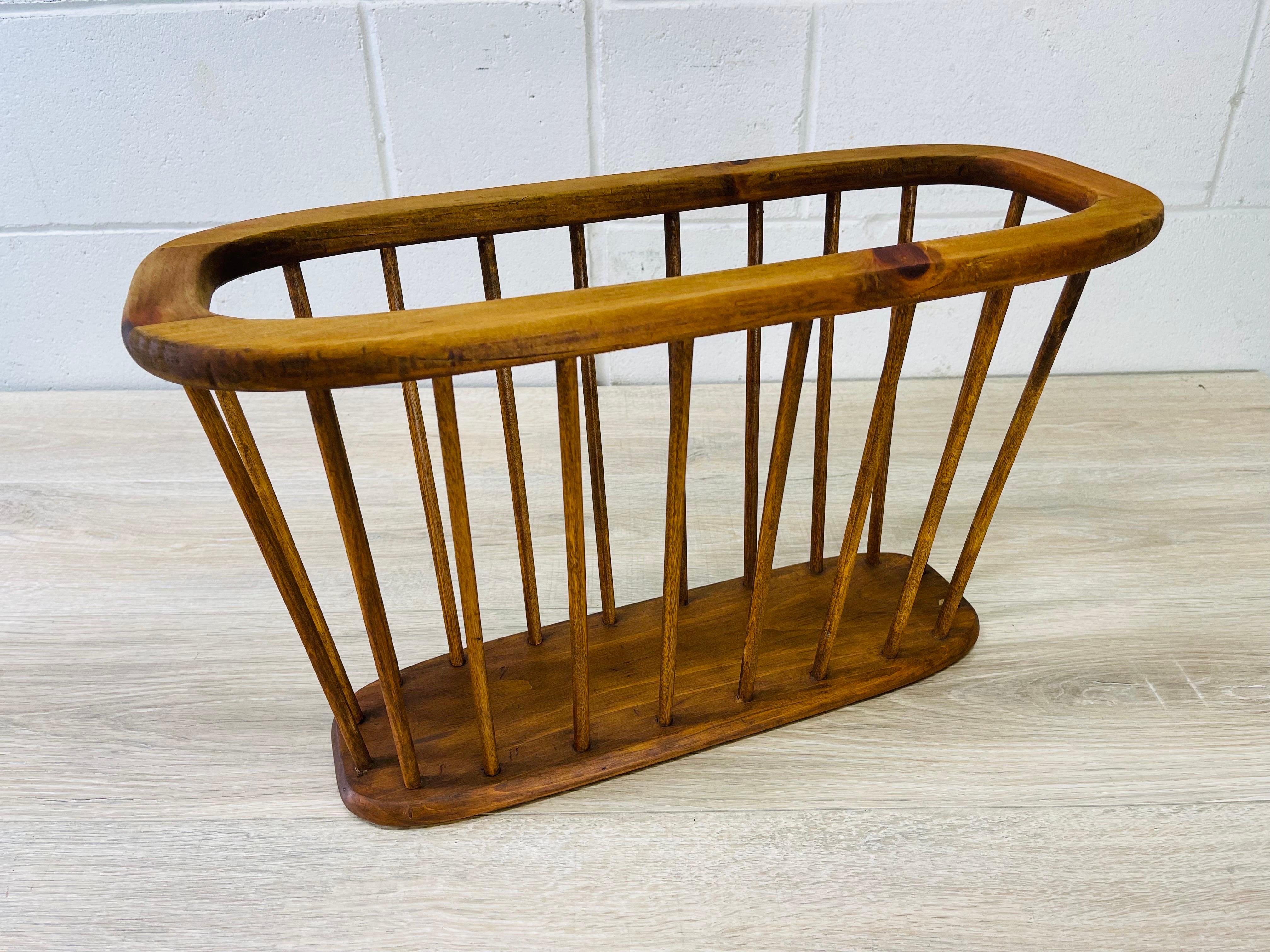 Vintage 1960s oval wood magazine rack with spindles. Newly refinished condition. No marks.