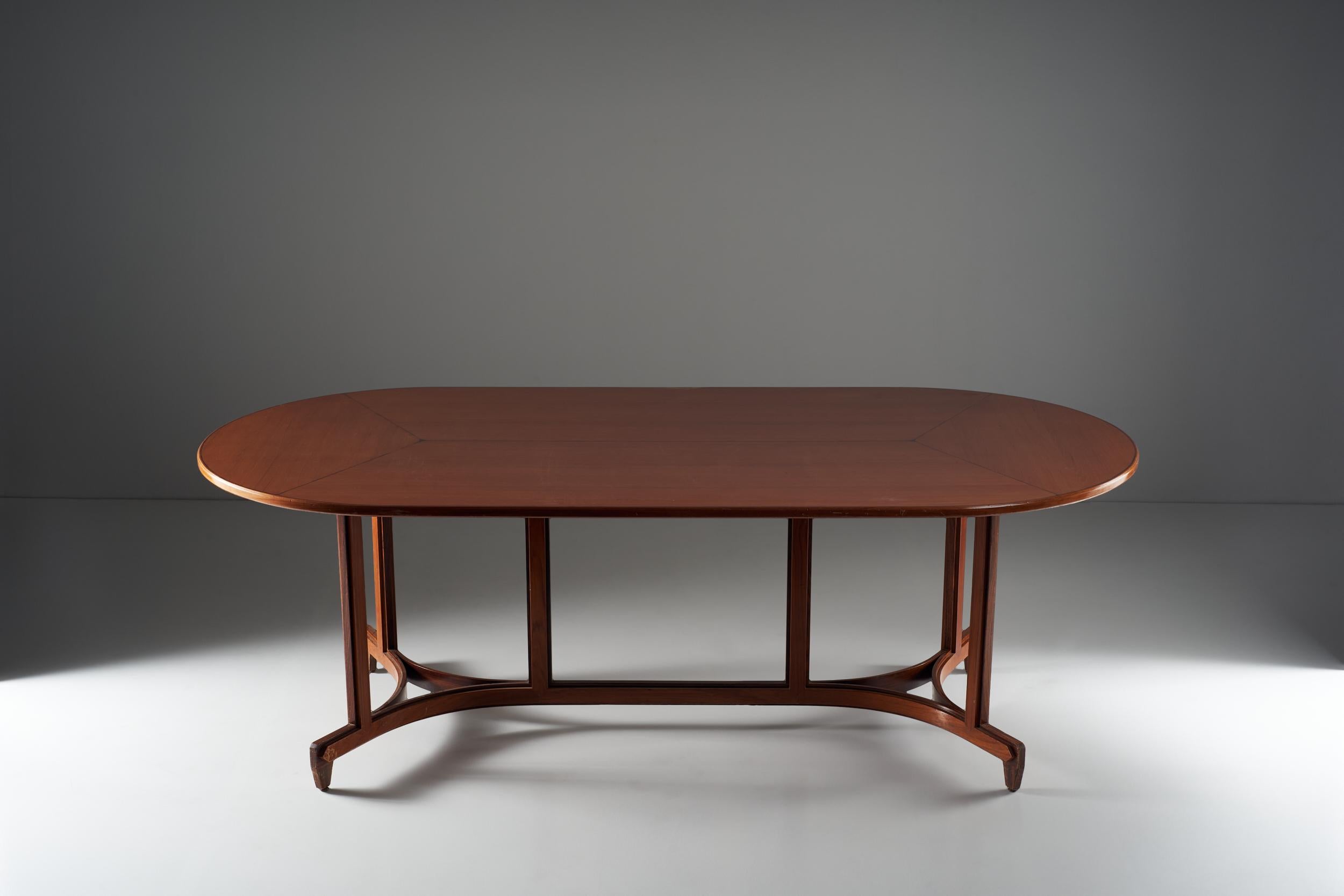 A masterfully executed wooden table, is composed by three main spaces along the underside to support a long and thin oval top with a complex and laborious structure. The feet rotates according to two distinct arches at the base of the table,