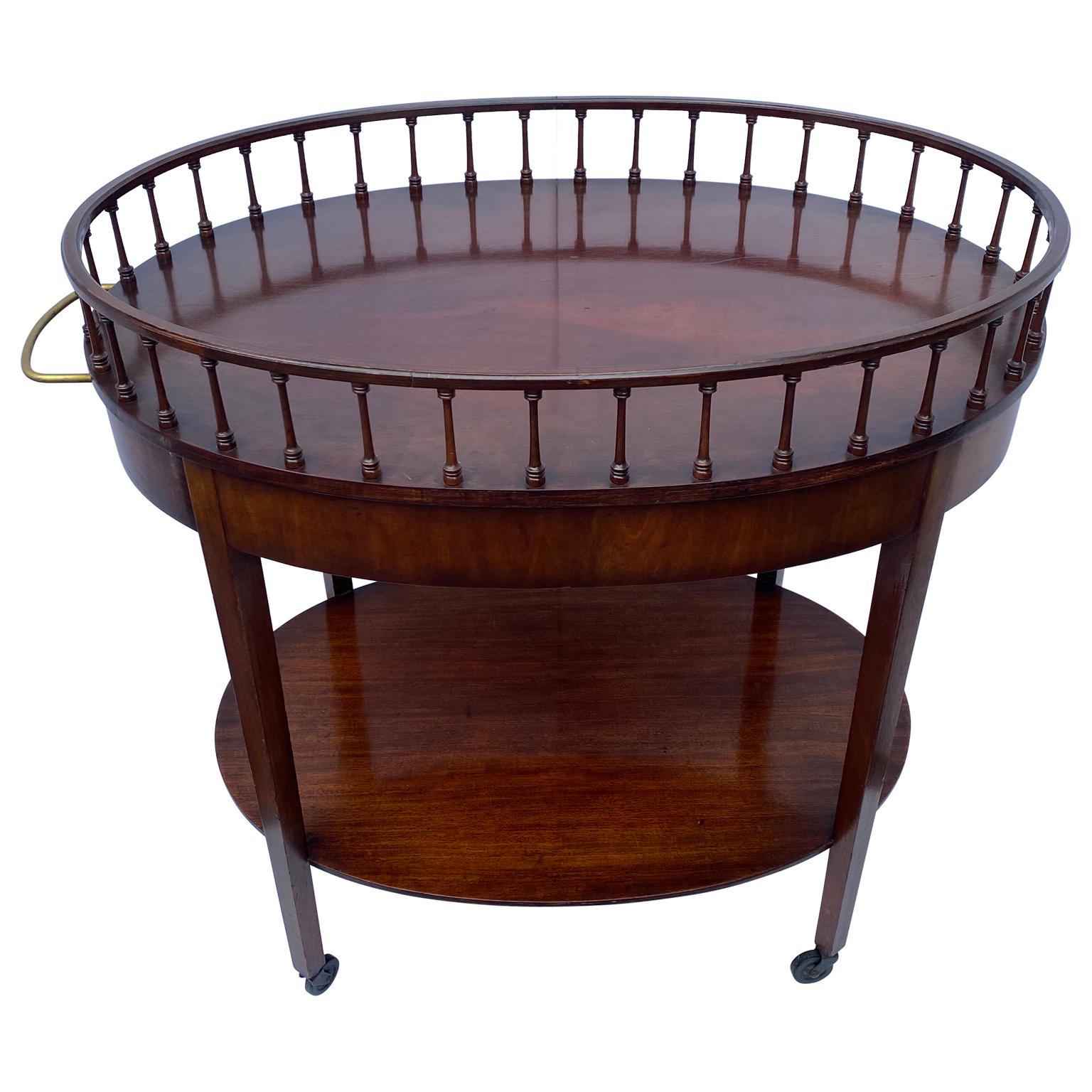 American two-tier oval tea on wheels, brass hardware and one drawer.