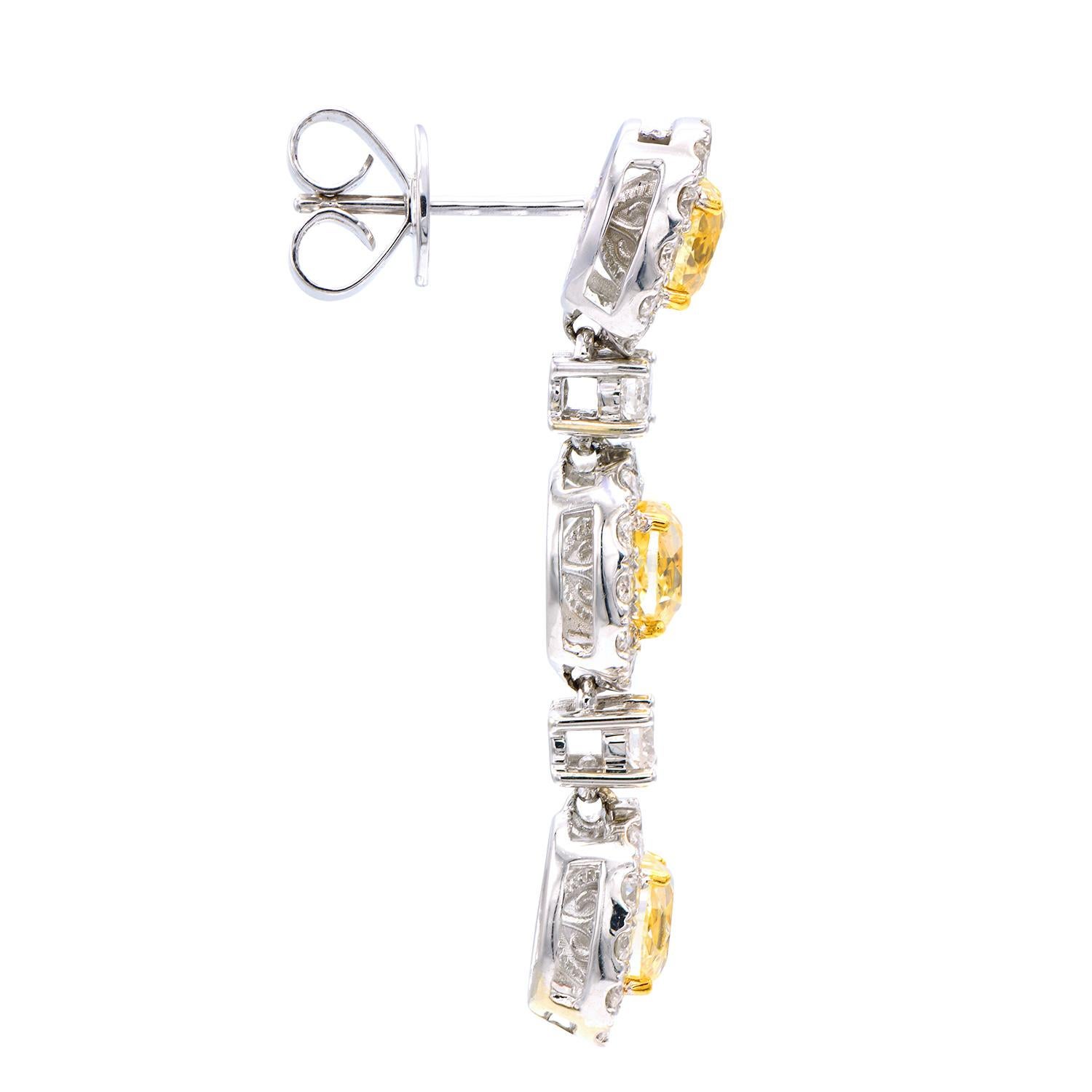 Classic beauty is the first thing that comes to mind when looking at these stunning earrings. 6 Fancy Yellow oval diamonds totaling 3.73 carats are surrounded by 76 round VS2, G color diamonds totaling 1.72 carats. They are set in 18 karat white
