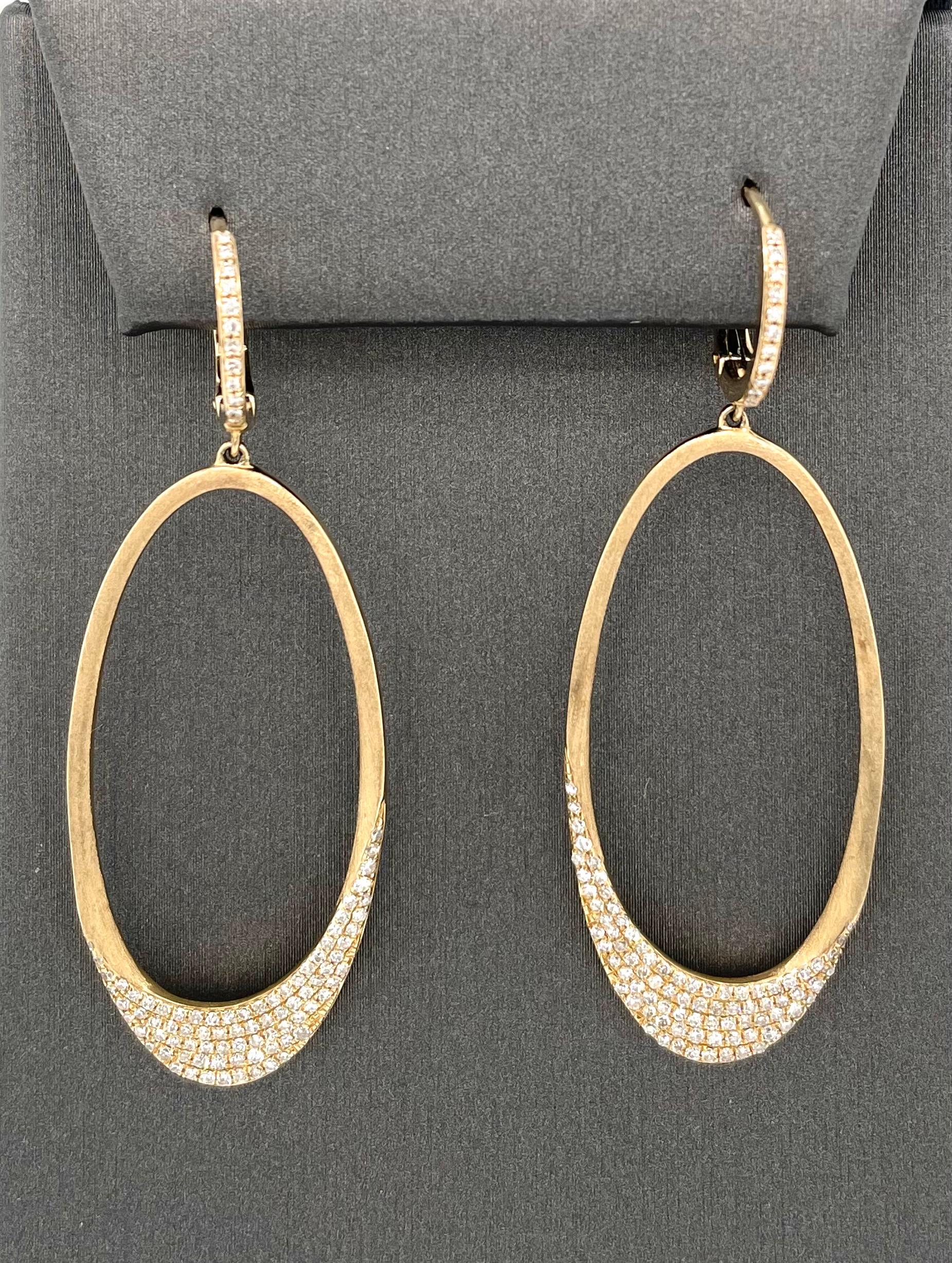 Classic and Modern looking earrings made to be worn daily.  These earrings are comfortable and transition from Day to night.  14K yellow gold and white diamond (.59 carat weight) oval dangle earrings.  A stylish 