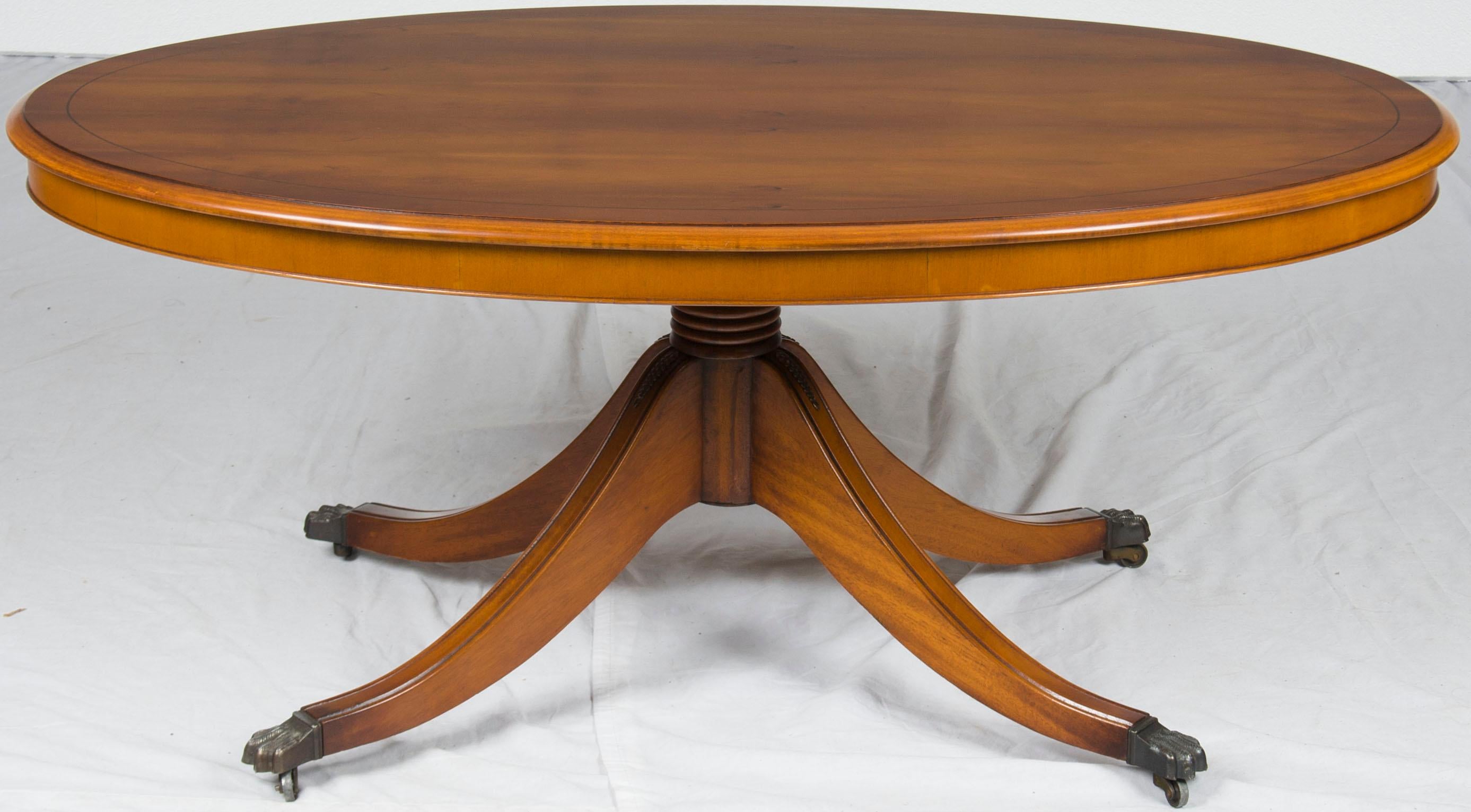 This antique oval coffee table was crafted in England around the year 1960. The rich yew would complement any setting, while the table itself remains very sturdy and in good overall condition.

The design elements used in this coffee table come