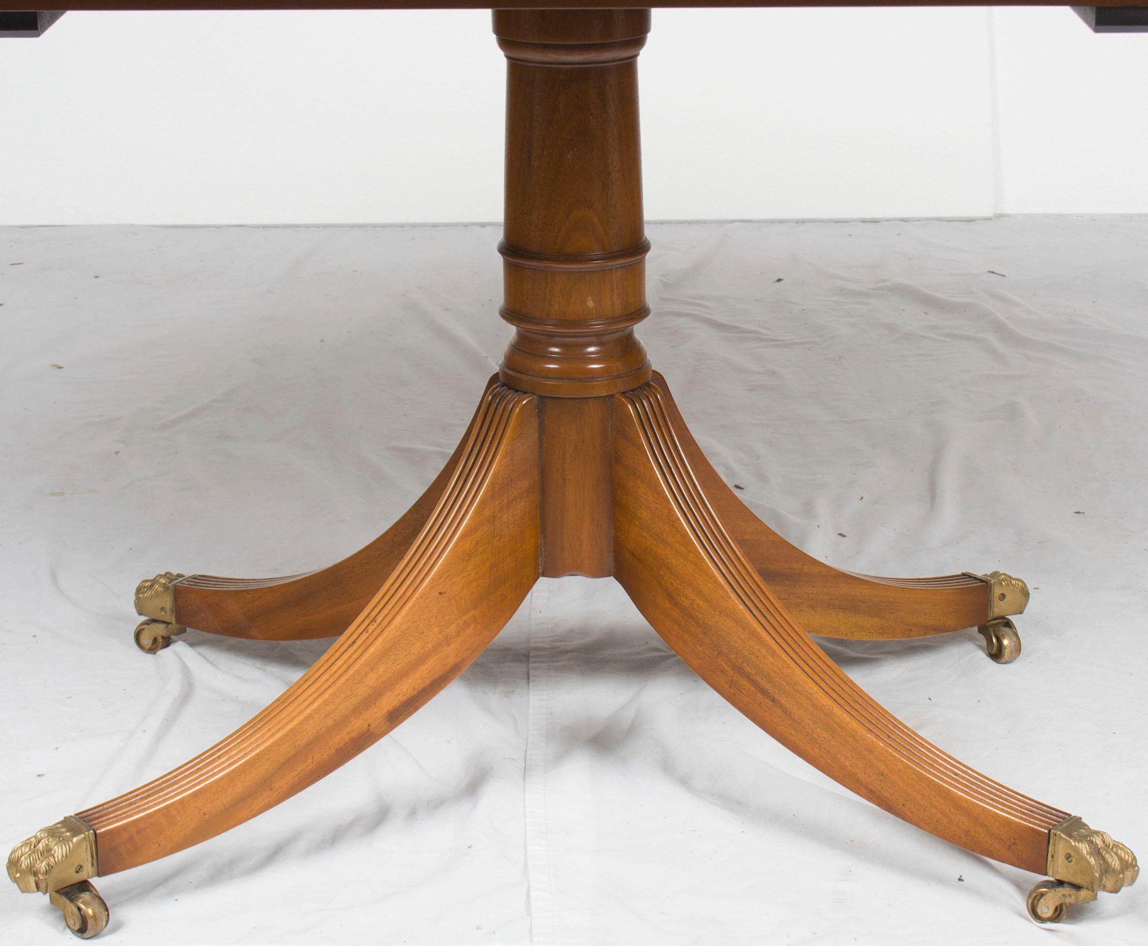 This gorgeous yew dining table was crafted in England in the year 1960 by Rackstraw. Today, the yew remains quite beautiful, with a rich complexion and a pronounced grain that are sure to complement any setting. With a single leaf that expands the