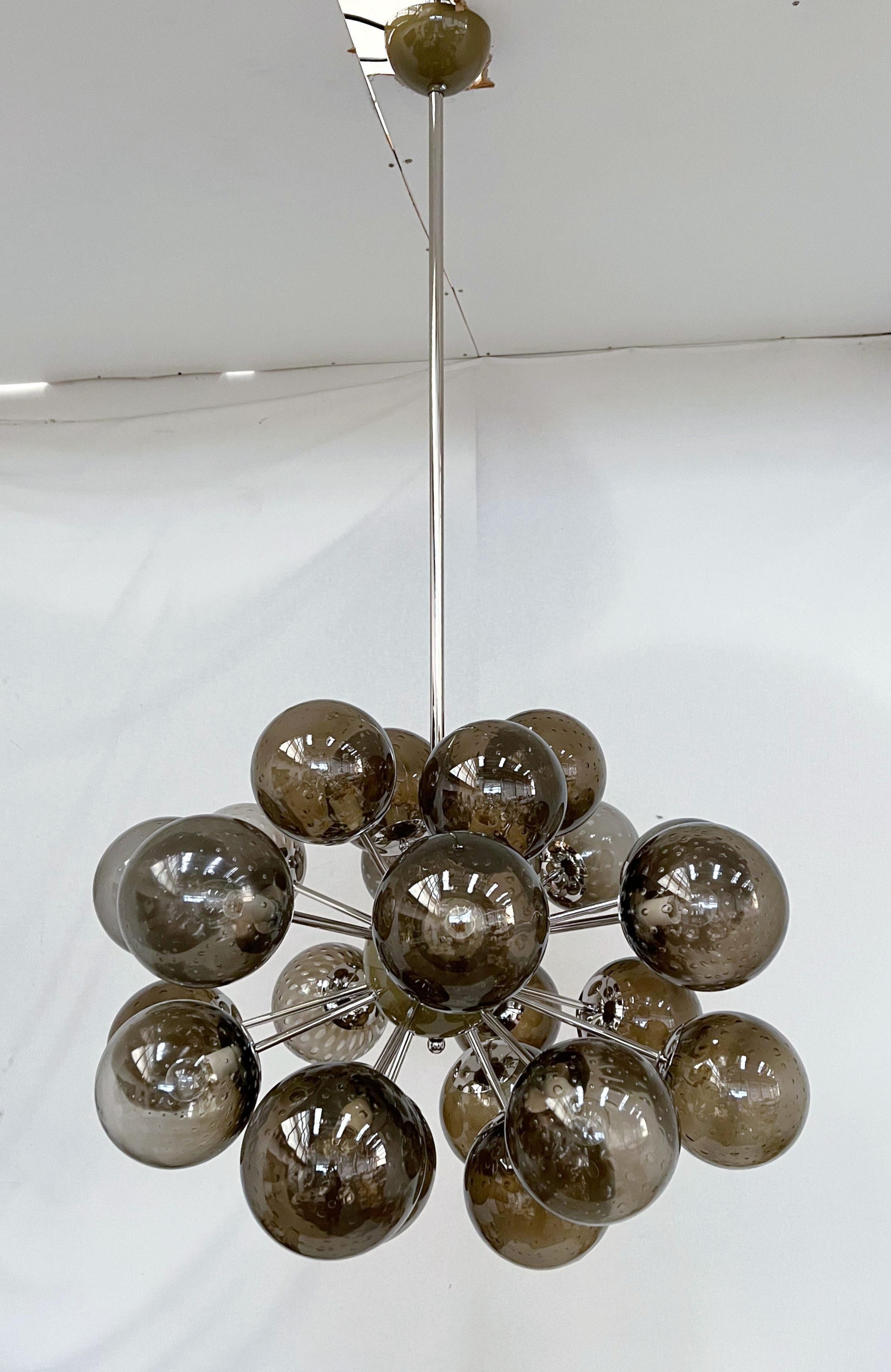 Lampadario italiano a forma di sputnik ovale con globi in vetro di Murano montati su una struttura in metallo con finitura in nichel lucido / Disegnato da Fabio Bergomi per Fabio Ltd / Made in Italy
24 luci / tipo E12 o E14 / max 40W