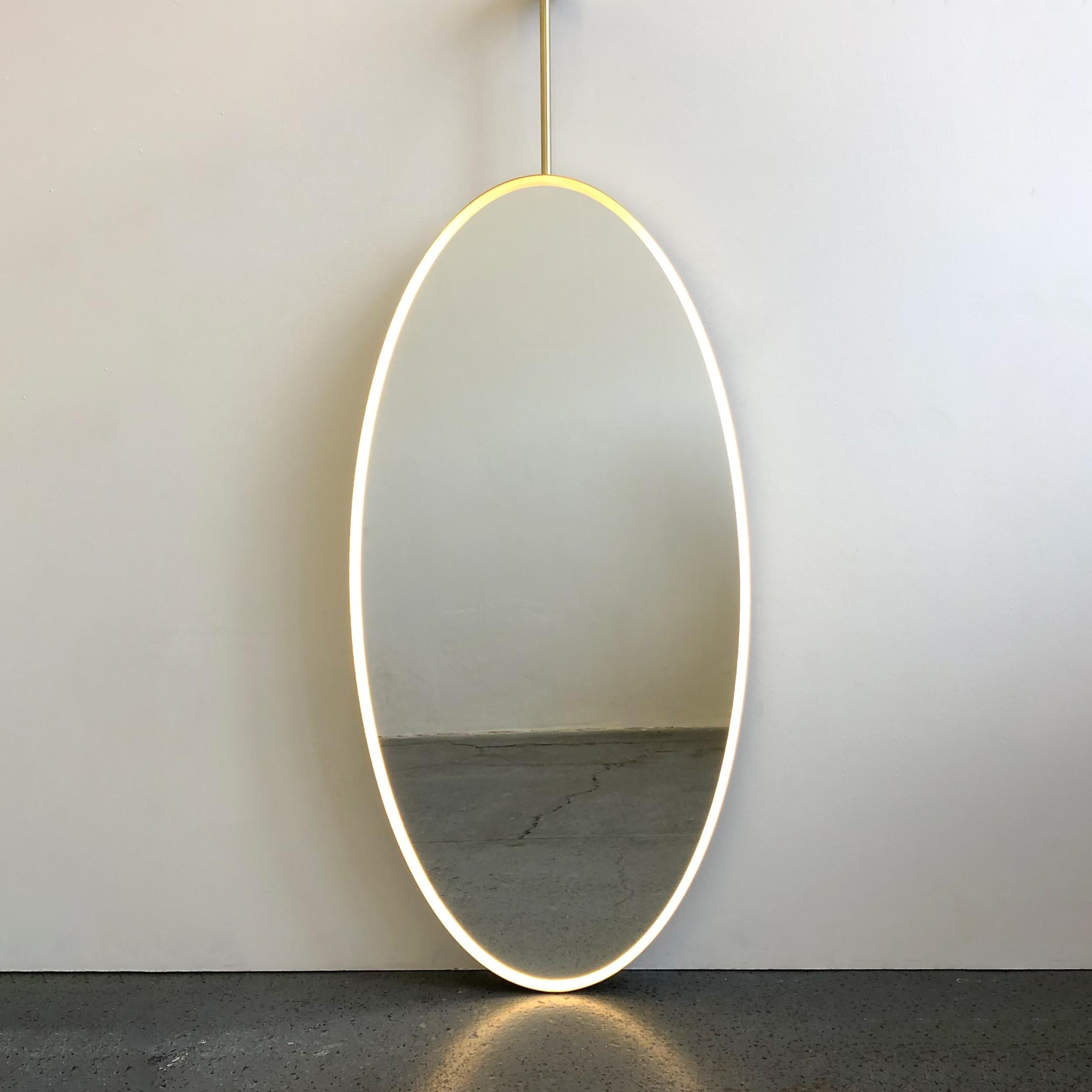 British Ovalis Ceiling Suspended Oval Mirror with a Brass Frame and Front Illumination For Sale