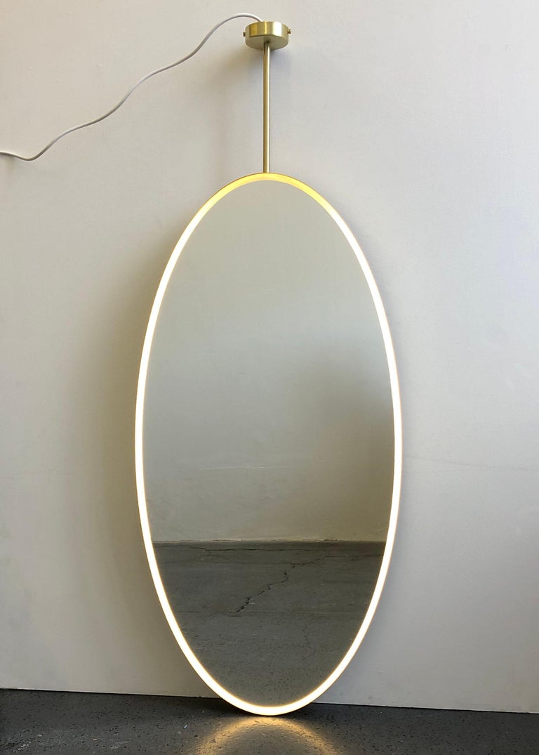 British Ovalis Suspended Mirror with a Brass Frame and Front Illumination, Customisable For Sale