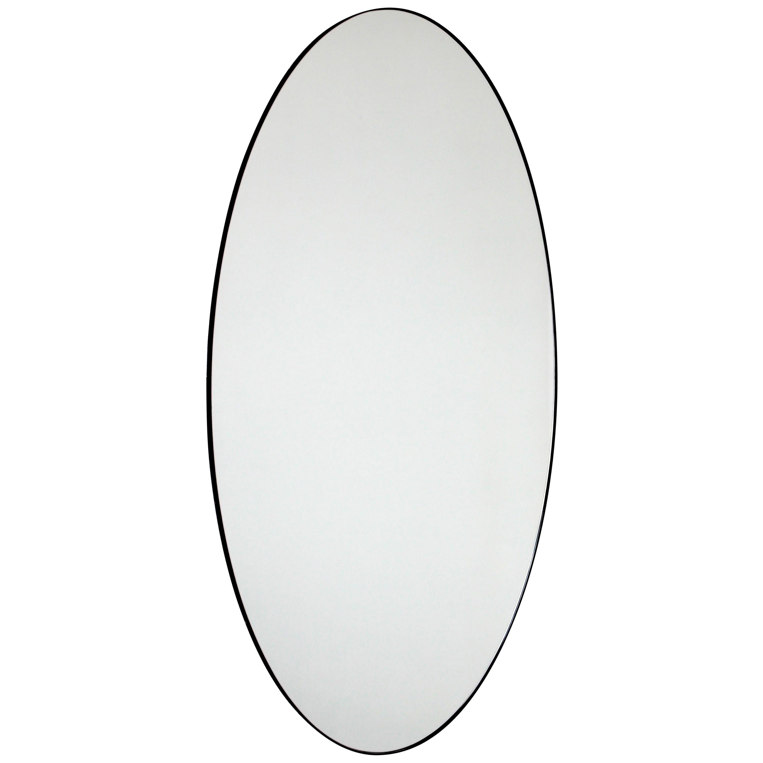 Delightful large oval mirror with a contemporary aluminium powder coated black frame. Designed and handcrafted in London, UK. 

Medium, large and extra-large (37cm x 56cm, 46cm x 71cm and 48cm x 97cm) mirrors are fitted with an ingenious French