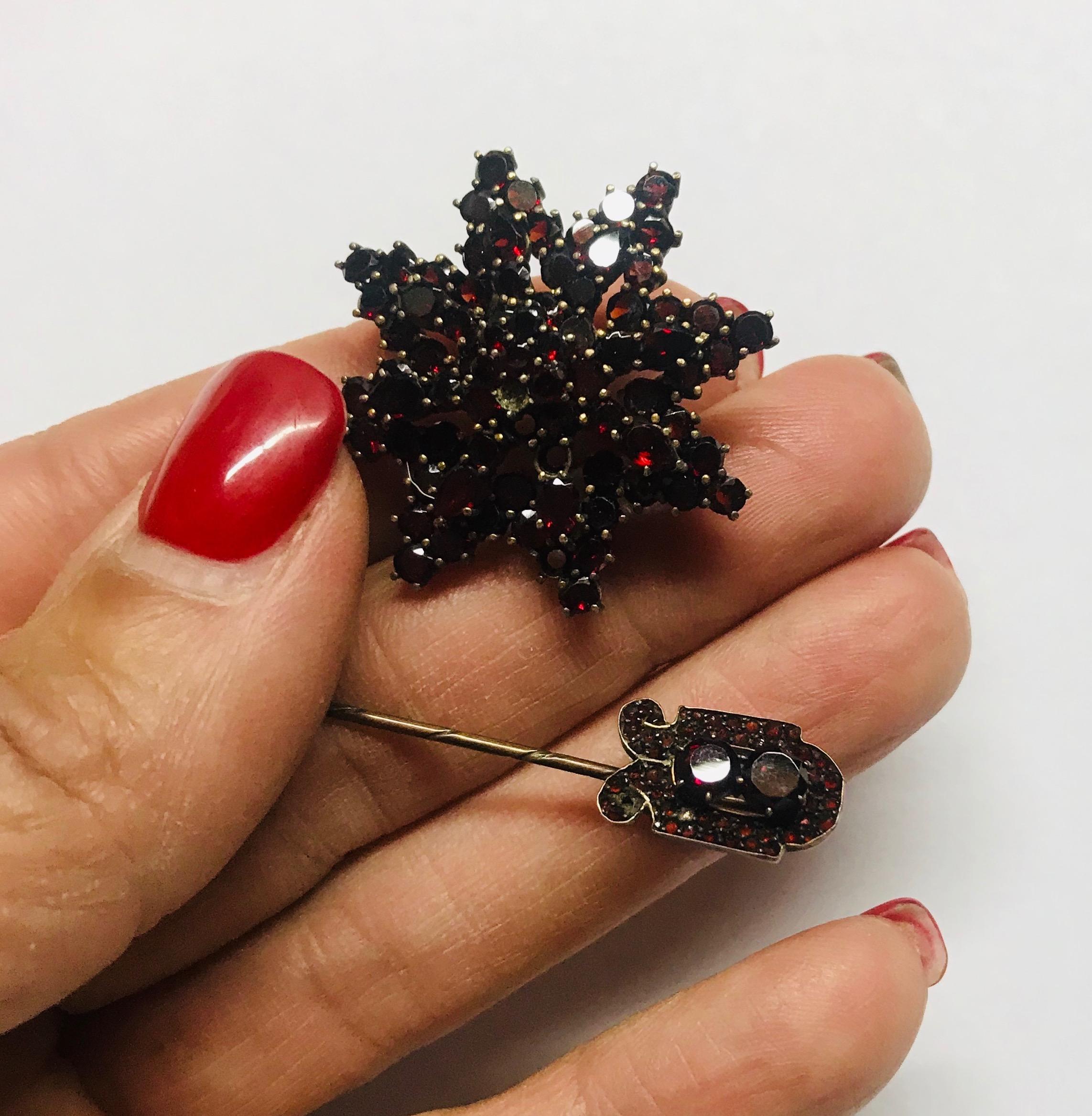 Oveka, 1920's Garnet Pn Set Victorian Era Large Starburst measures 1-1/2 inch diameter Round garnets and Pear Shaped garnets,  set in prongs. Hallmarked Oveka and is tested as 12 karat yellow gold Pin measures 2 inch length with antique cut round