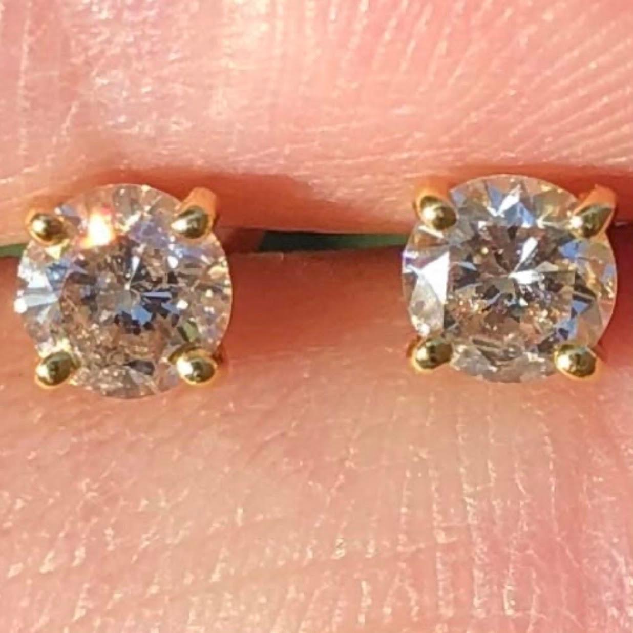 Classic over 1/2 Carat solitaire diamond stud earrings in 14k yellow gold. Pair of natural earth-mined round brilliant diamonds weighing approx. 0.62 carats are prong-set in these 14K basket studs.

Diamond stud earrings come with a fine velvet