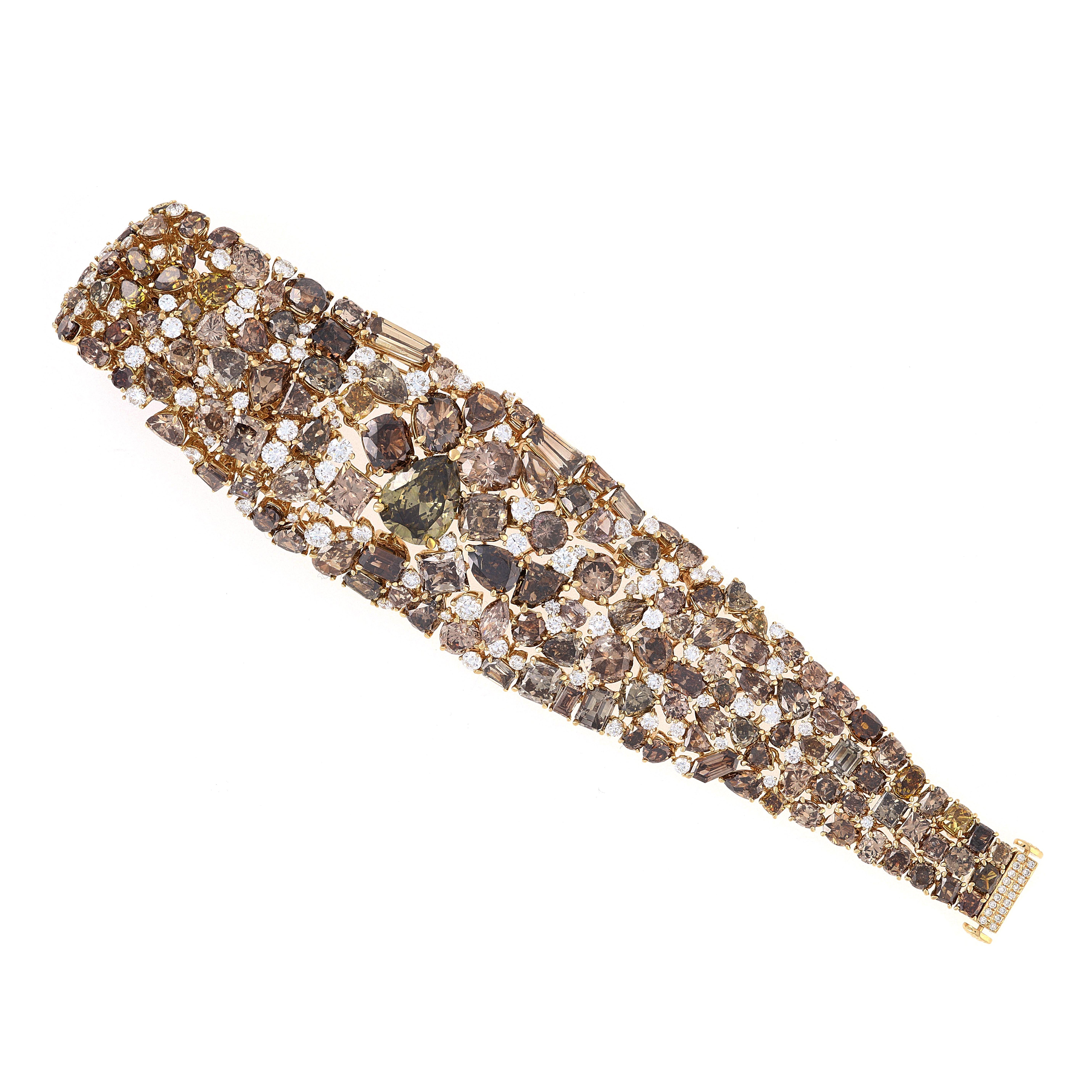 Talk about a big look! This bracelet has over 81 carats of brown and yellow diamonds set beautifully in 18kt yellow gold. The center pear shape is about 5 carats just by itself. This bracelet is made so well that it can actually be rolled. We have