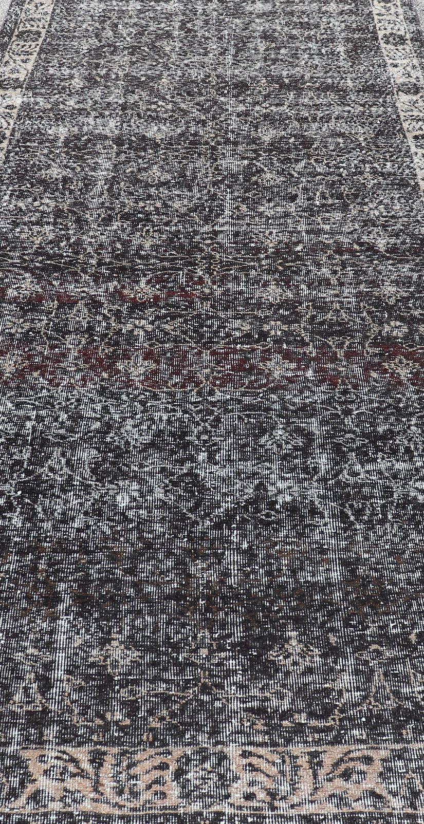 Over dyed in charcoal, cream & grays gallery oushak with all-over floral design.
Keivan Woven Arts / rug EN-P13612, country of origin / type: Turkey / Oushak, circa Mid-20th Century.

Measures: 4'10 x 12'6.