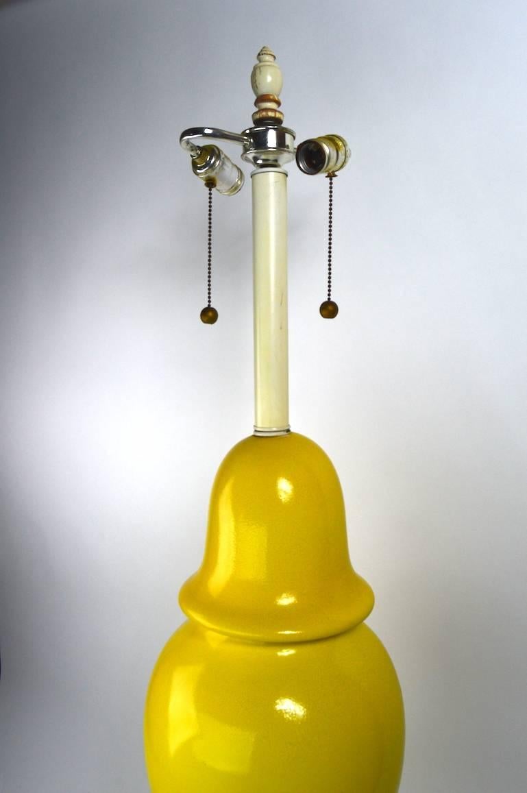 Fun large yellow ceramic table lamp of classic ginger jar form. This example is in good, original and working condition, the yellow glaze finish shows minor loss in spots, as pictured in the listing. It features a two light socket each of which can