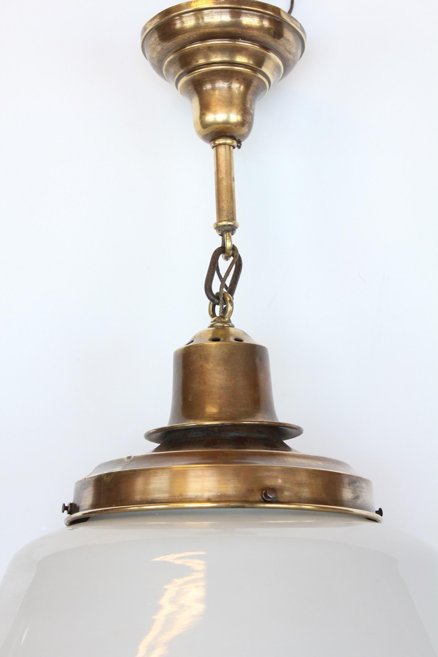Over sized antique school light with milk glass shade and brass hardware. Four-lights available. Listed price is for each light