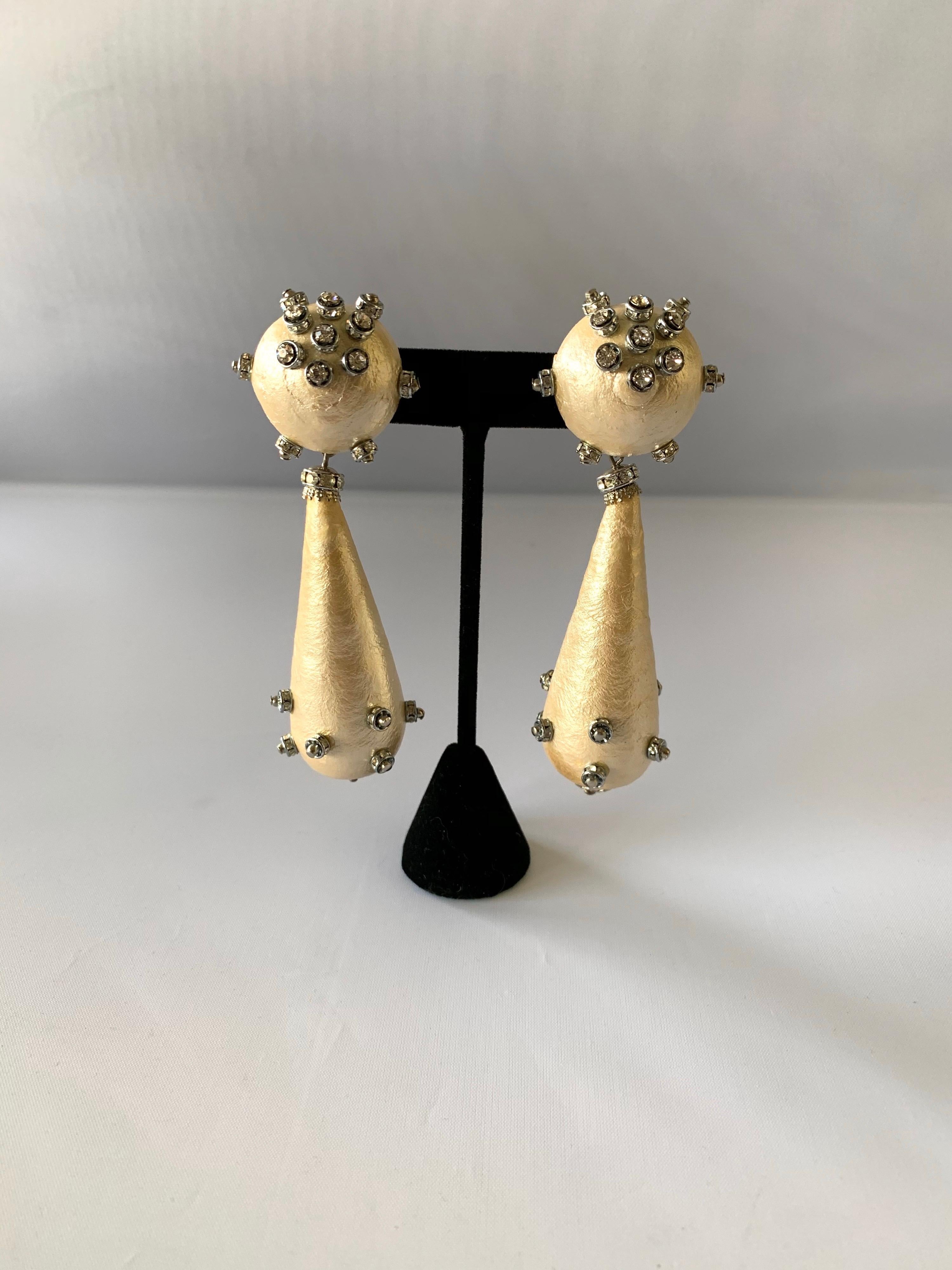 Over-sized contemporary drop statement earrings comprised out of cotton nacred pearls - the earrings are accented by silver-tone details and diamante 