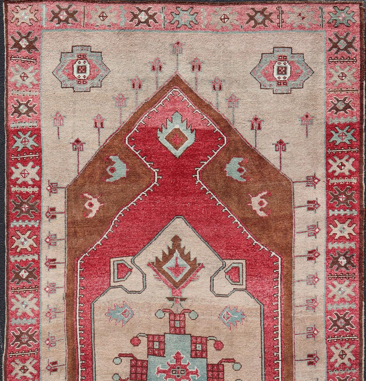 Vintage wide Gallery runner from Turkey with Medallion design in various tones of Red, light raspberry, taupe. and brown rug EN-179982, country of origin / type: Turkey / Kars, circa 1940

This beautiful vintage Turkish Kars gallery rug from 1940s