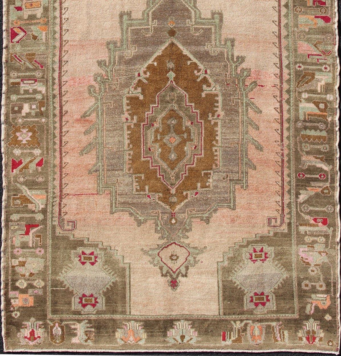 Vintage wide Gallery runner from Turkey with Medallion design in various tones of blush, salmon, light pink, various shades of greens and browns rug en-165931, country of origin / type: Turkey / Kars, circa 1940

This beautiful vintage Oushak runner