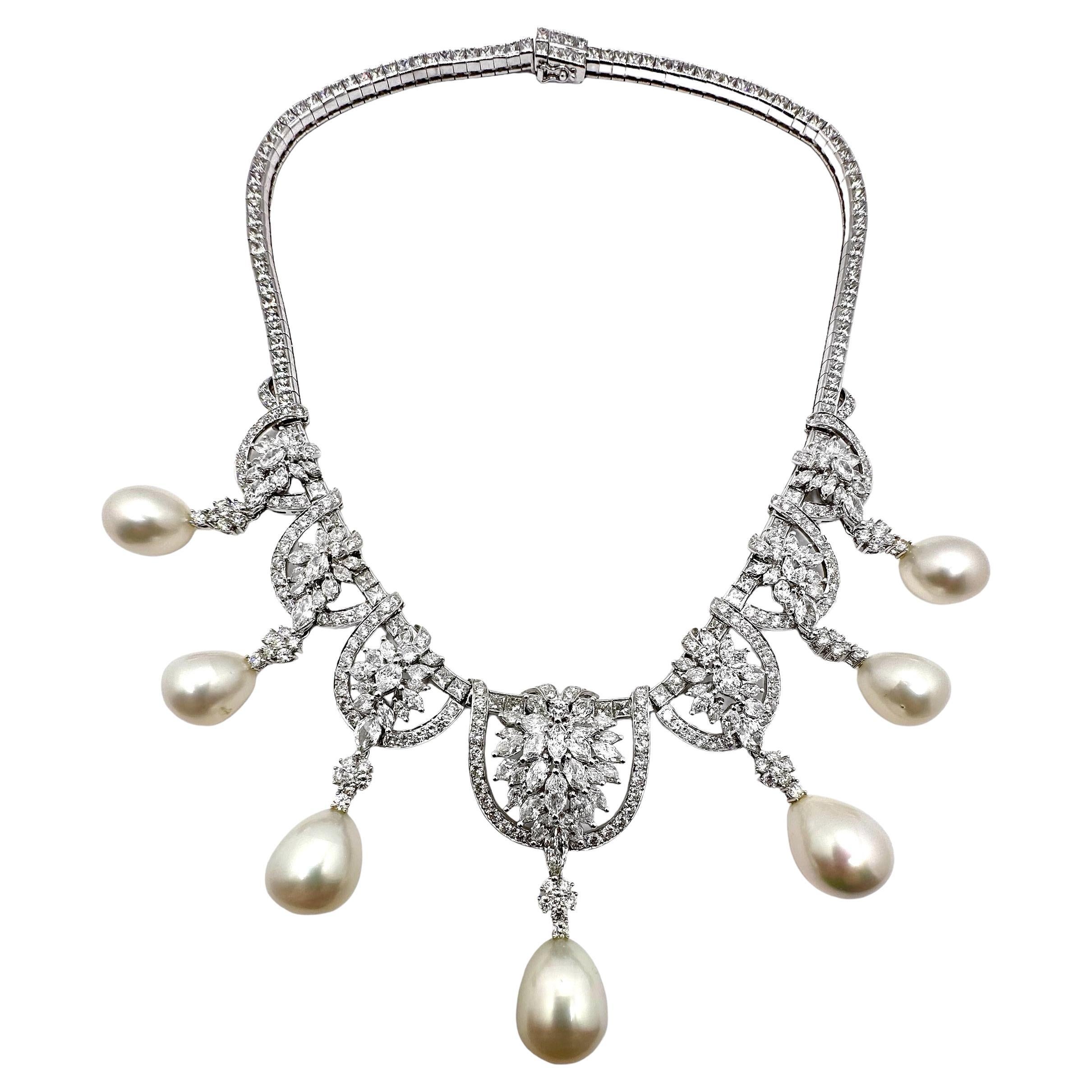 This amazing platinum cocktail necklace is replete with assorted round brilliant cut, marquise cut, and princess cut diamonds. At the end of each of the seven stations in the front, are removable south sea pearl and diamond hangers. The hangers are