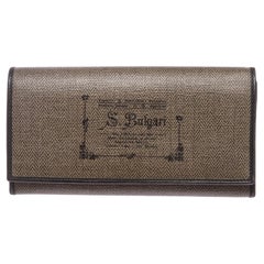 Overall flap snap closure. Interior is leather lined with ten credit card slip
