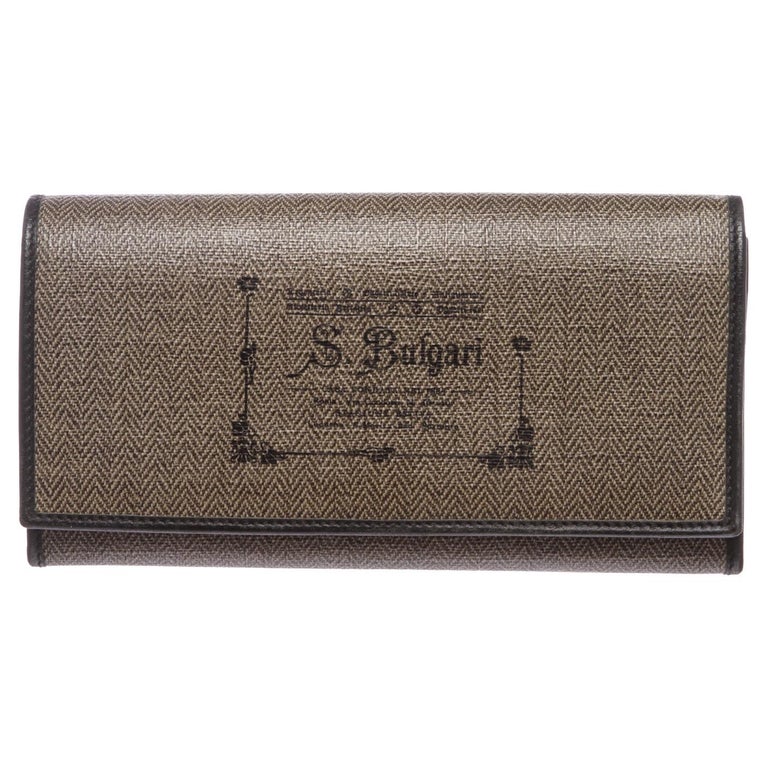 Overall flap snap closure. Interior is leather lined with ten credit ...