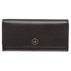 Overall flap snap closure with embellishment. Interior is leather and fabric