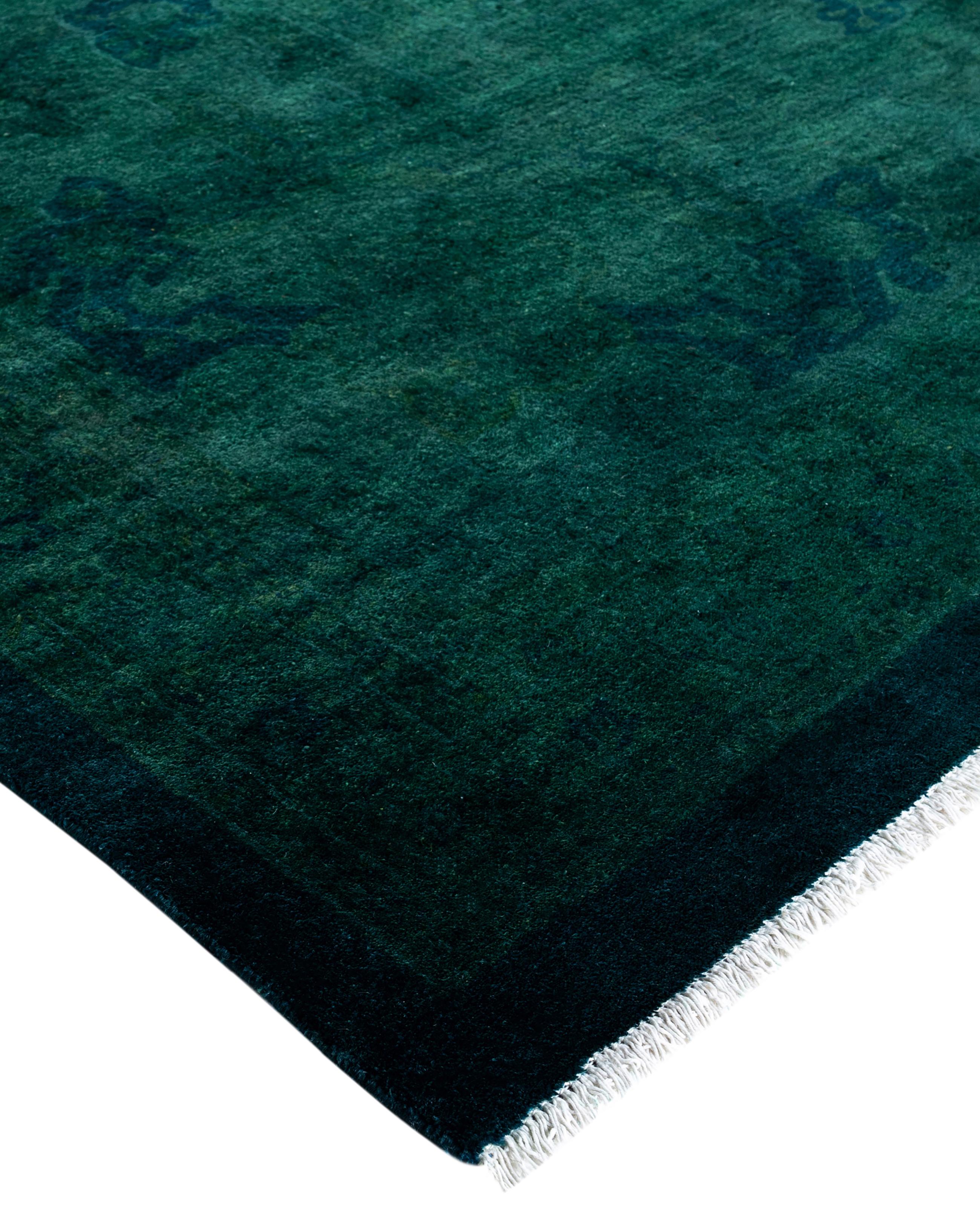 Over-dyed area rugs are created by taking vintage or traditional rugs and applying a vibrant, monochromatic dye over the existing patterns. This technique results in a bold, modern aesthetic while preserving the intricate designs beneath, blending