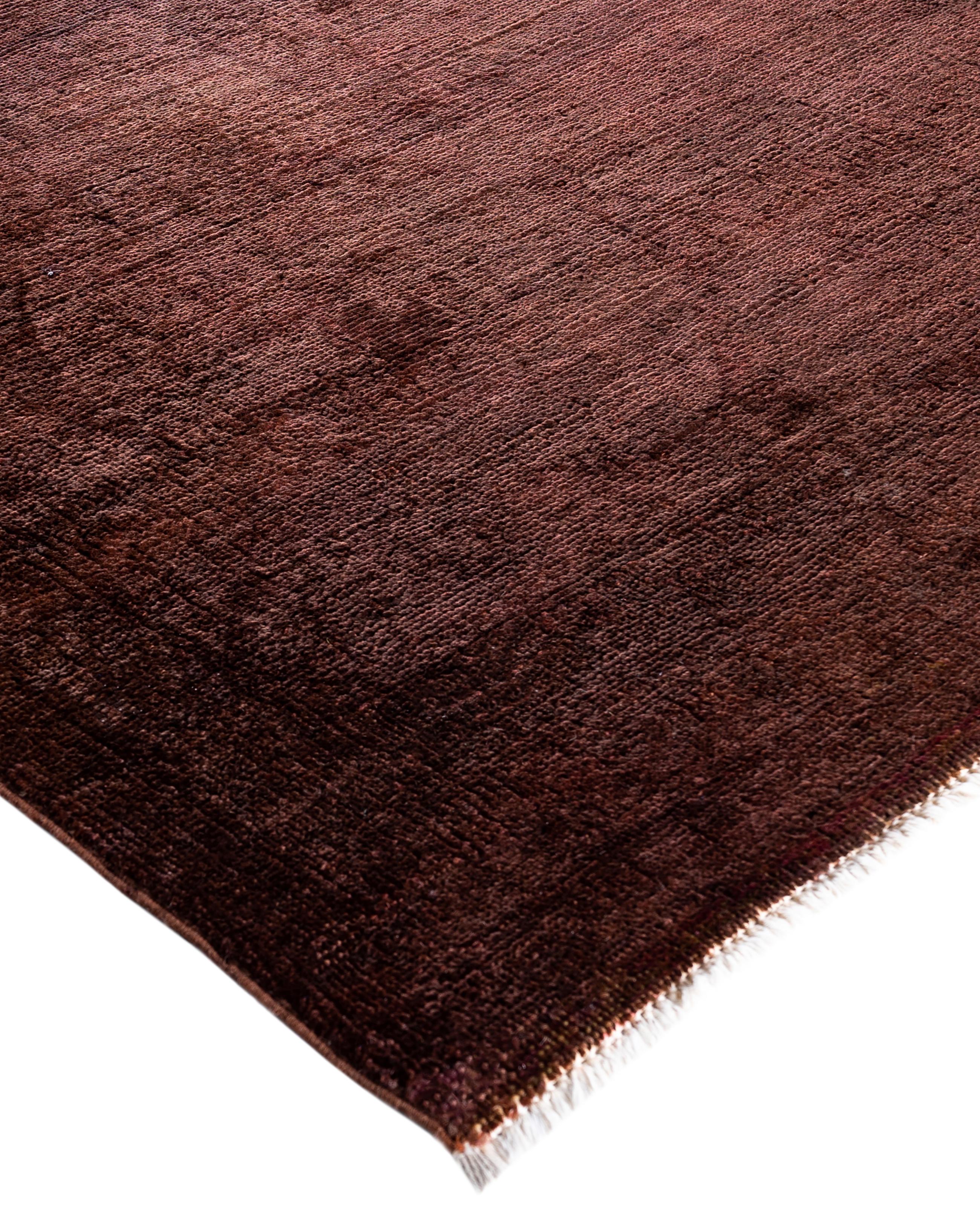 Over-dyed area rugs are created by taking vintage or traditional rugs and applying a vibrant, monochromatic dye over the existing patterns. This technique results in a bold, modern aesthetic while preserving the intricate designs beneath, blending