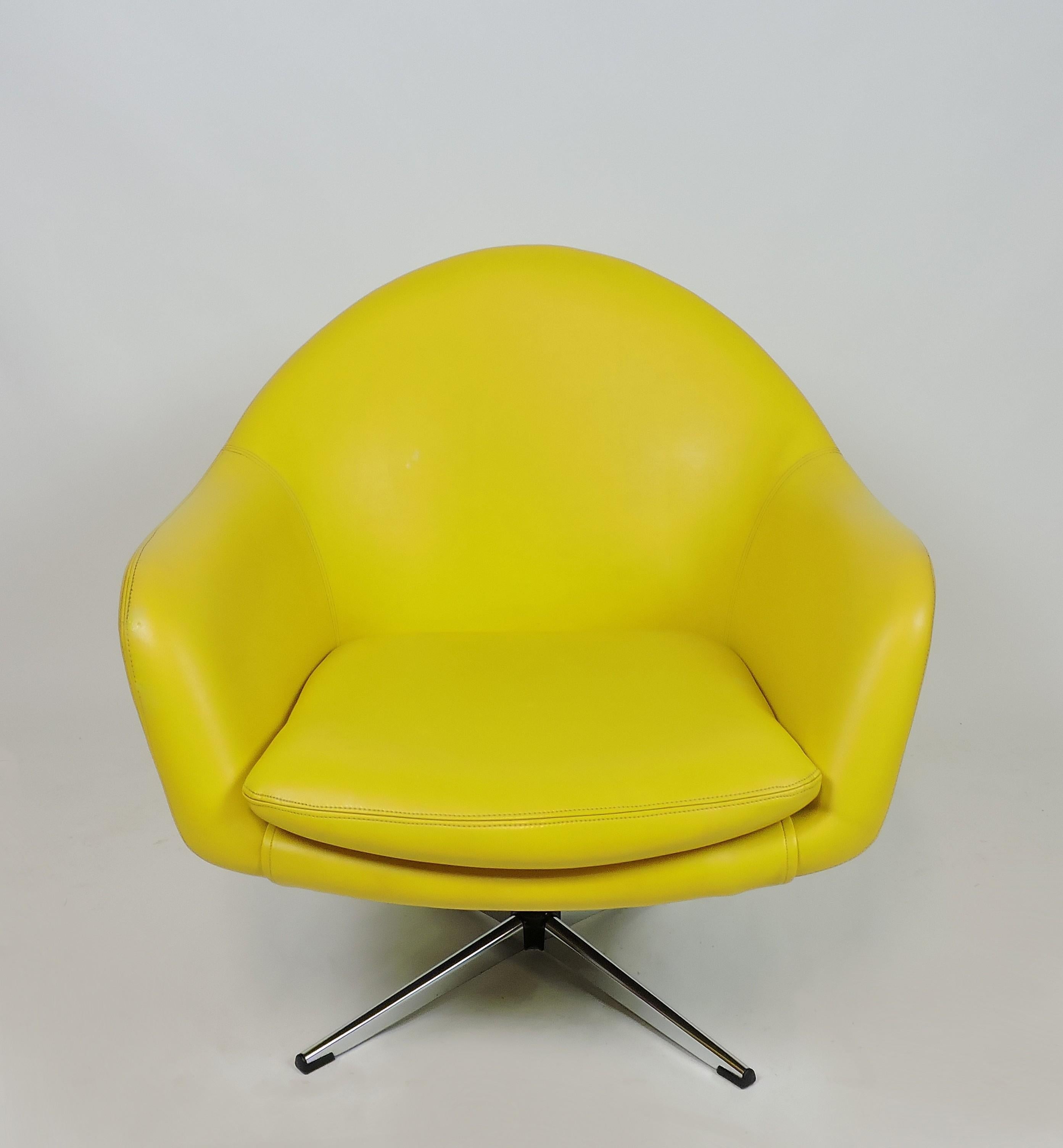 Very cool swivel chair with a chrome base by Overman. This chair is light weight and sturdy and is upholstered in lemon yellow vinyl for a pop of color.