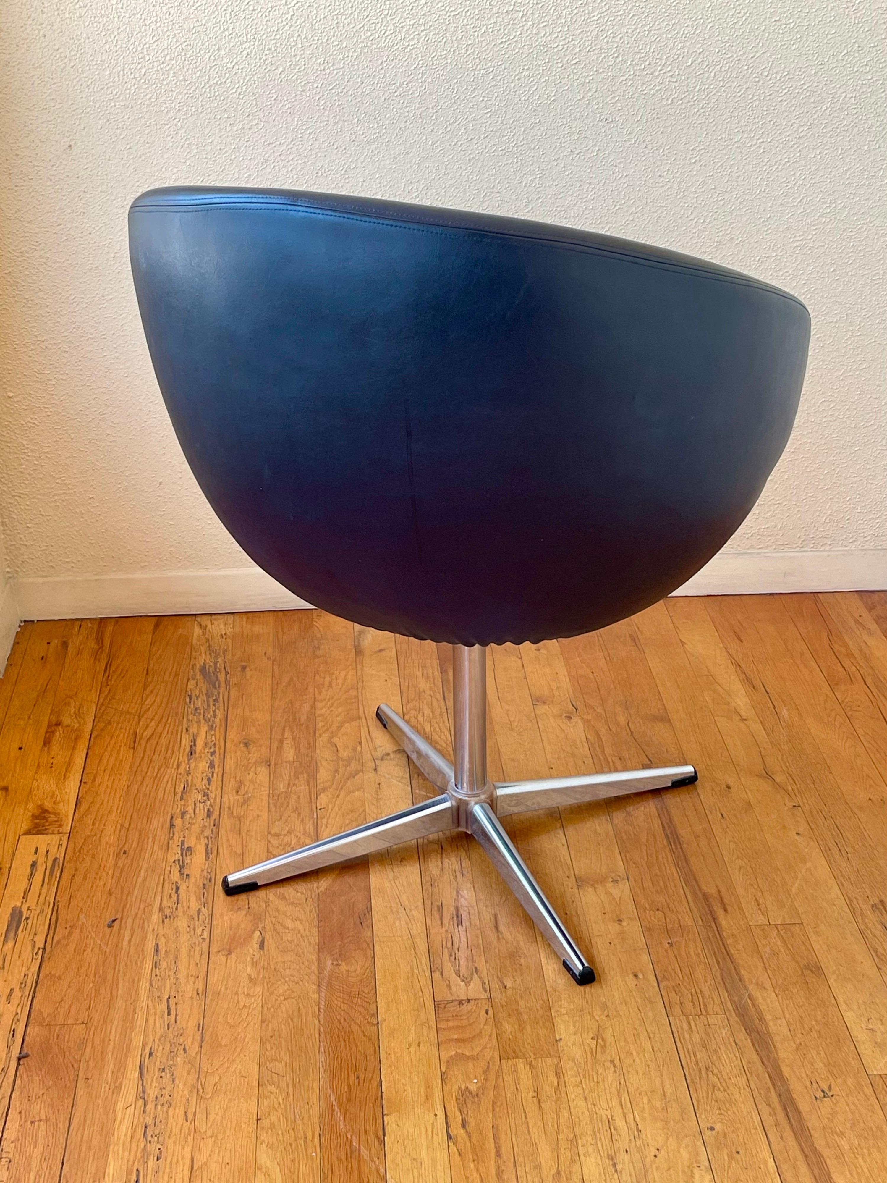Cool swivel single chair by Overman all original black Naugahyde and chrome swivel base, circa 1960's, good original condition some wear due to age.