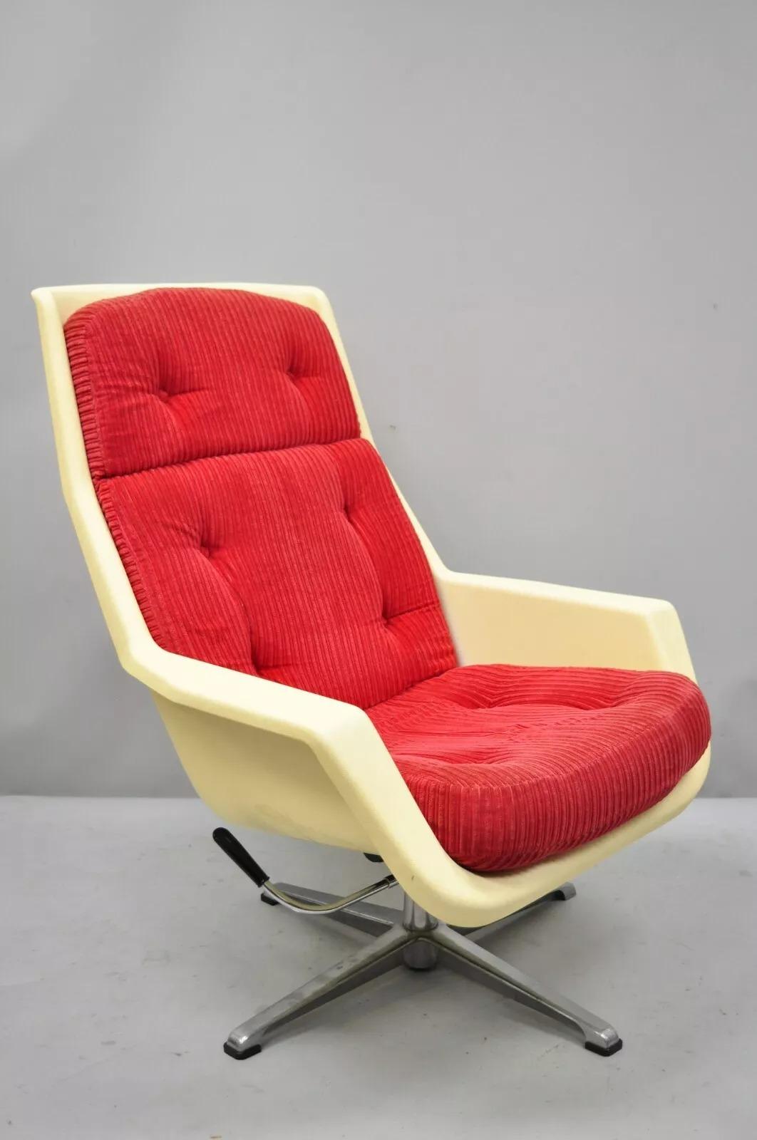 Vintage Mid Century Modern Molded Plastic Swivel Tilt Atomic Era Lounge Chair attributed to Overman of Sweden. Item features a swivel and tilt metal base, red loose cushions, very nice vintage item, sleek sculptural form, base can be affixed from