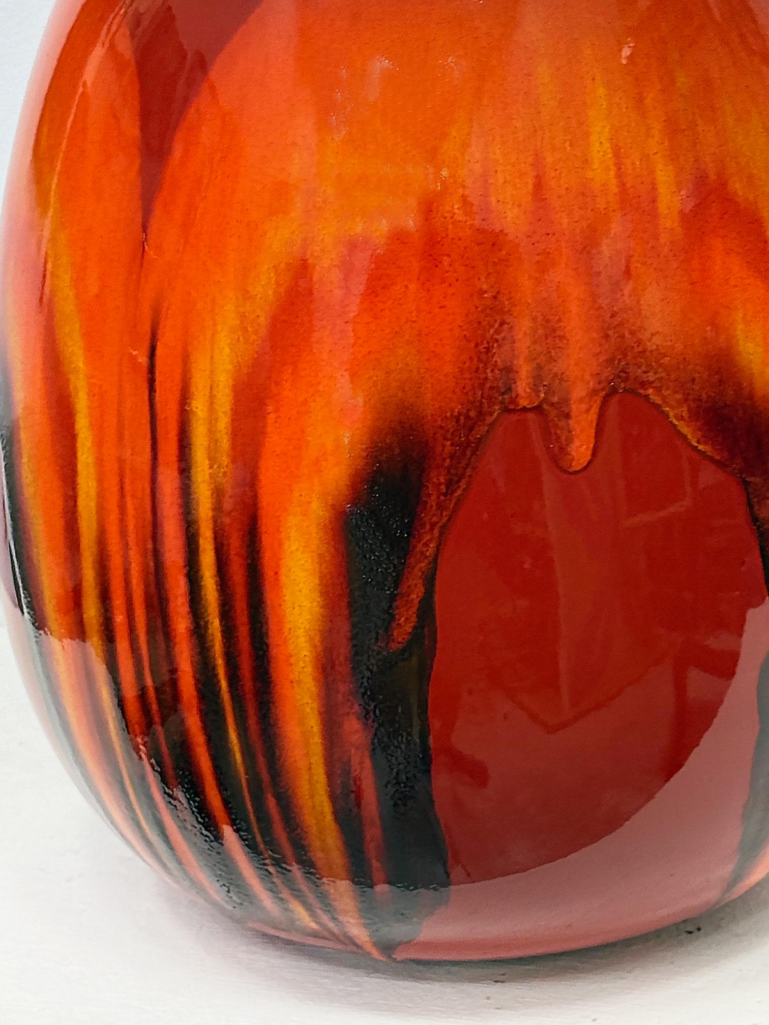 Overscale Mid-century Danish Modern Bulbous Drip Glaze Lamp

Offered for sale is a striking oversized Mid-century Danish Modern bulbous orange drip glaze table lamp. The lamp has an iconic high gloss glazed finish with rich red to orange to black