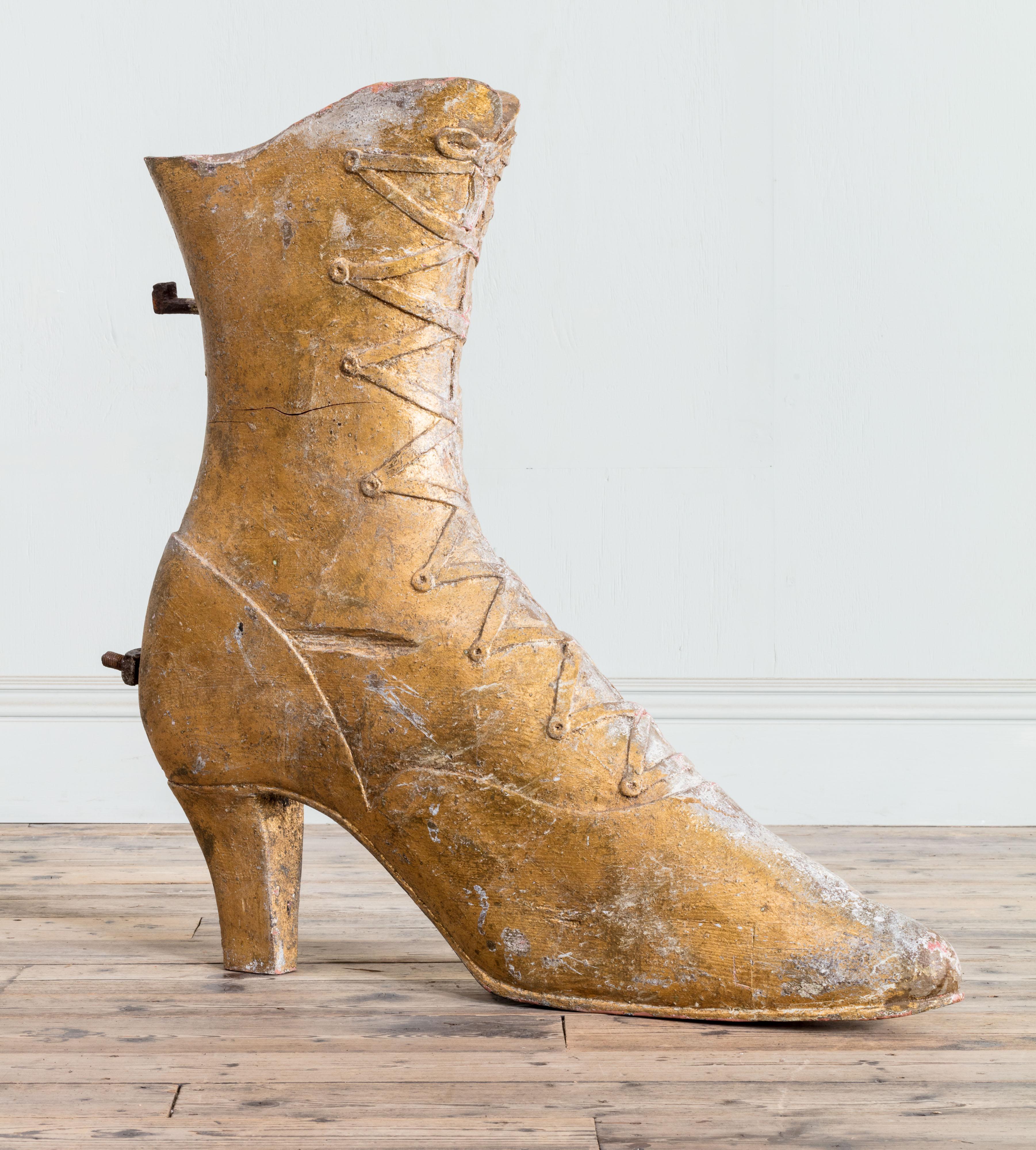 Chaussure en bois doré surdimensionné du 19e siècle.

Informations complémentaires :
Dimensions : Hauteur : 99 cm, 39″.
Largeur (longueur) : 104 cm, 41″.
Profondeur : 15 cm, 5 7/8″.