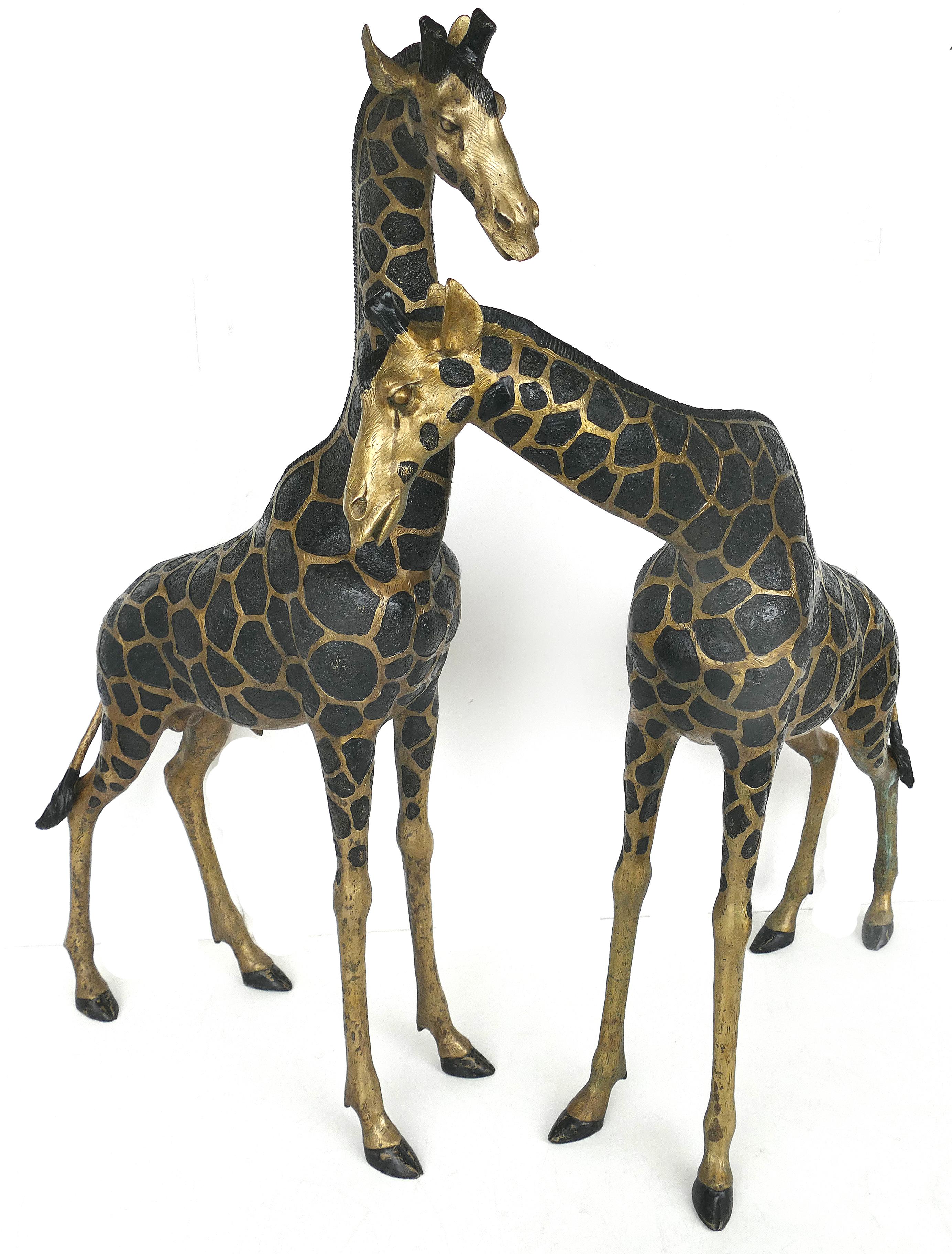 Overscale Hollywood Regency brass giraffe sculptures, pair

Offered for sale is a very large pair of Hollywood Regency brass giraffe sculptures. The pieces can be situated in various positions to create interesting and natural arrangements.
The