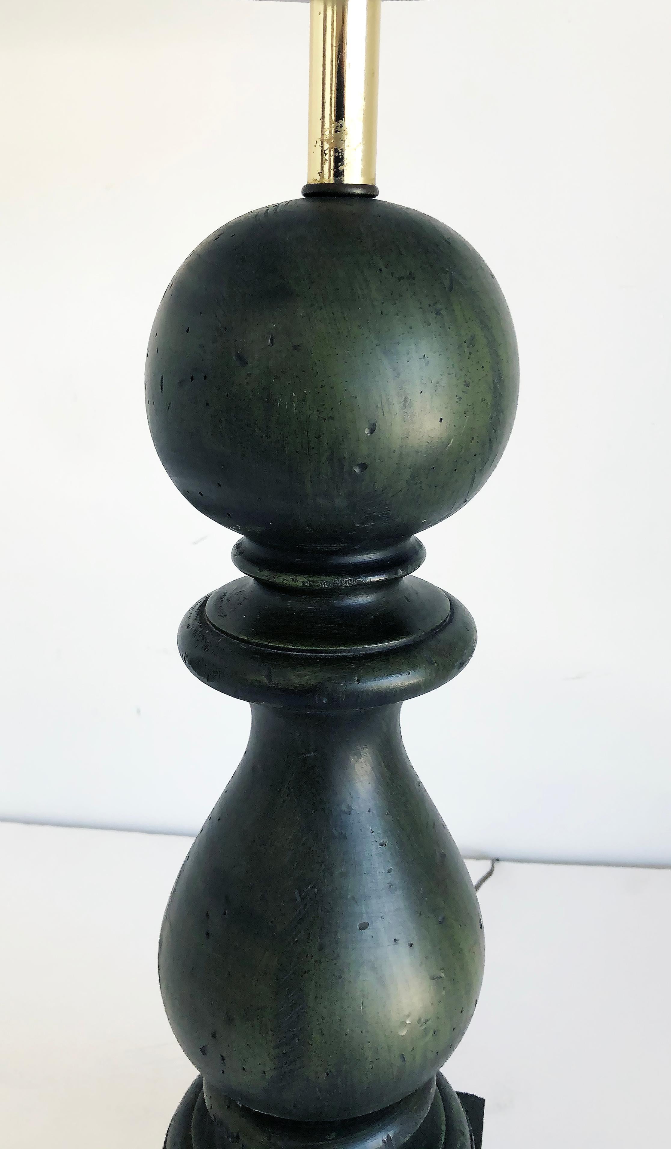 Overscale vintage carved wood Balustrade table lamps

Offered for sale is a pair of overscaled turned carved wood lamps on a giltwood base. The lamps are created in a balustrade form with the wood having been stained in dark green. The lamps are