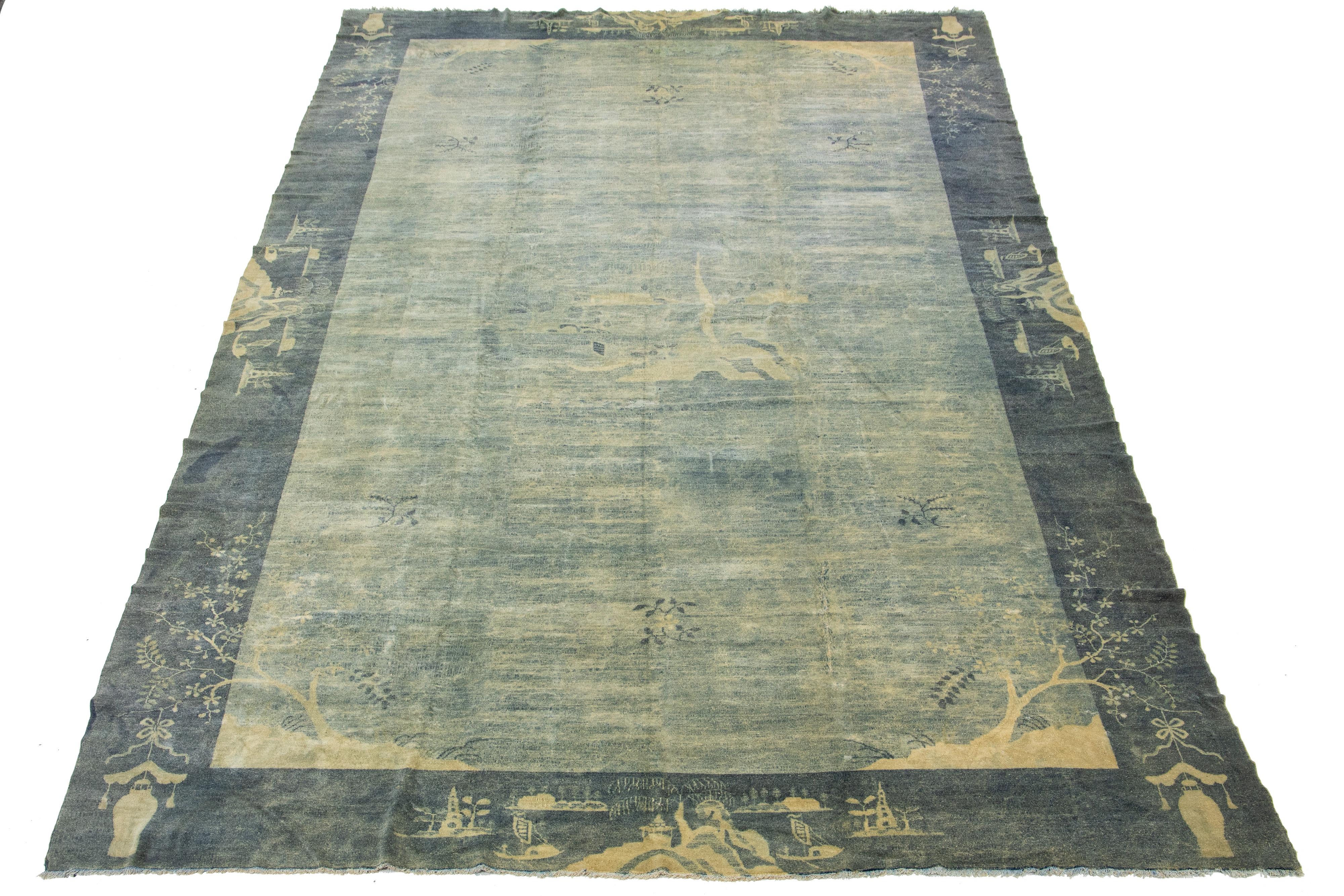 This Art Deco Chinese rug is made of hand-knotted wool and features a gray and beige field with a stunning designed frame.

This rug measures 11'10