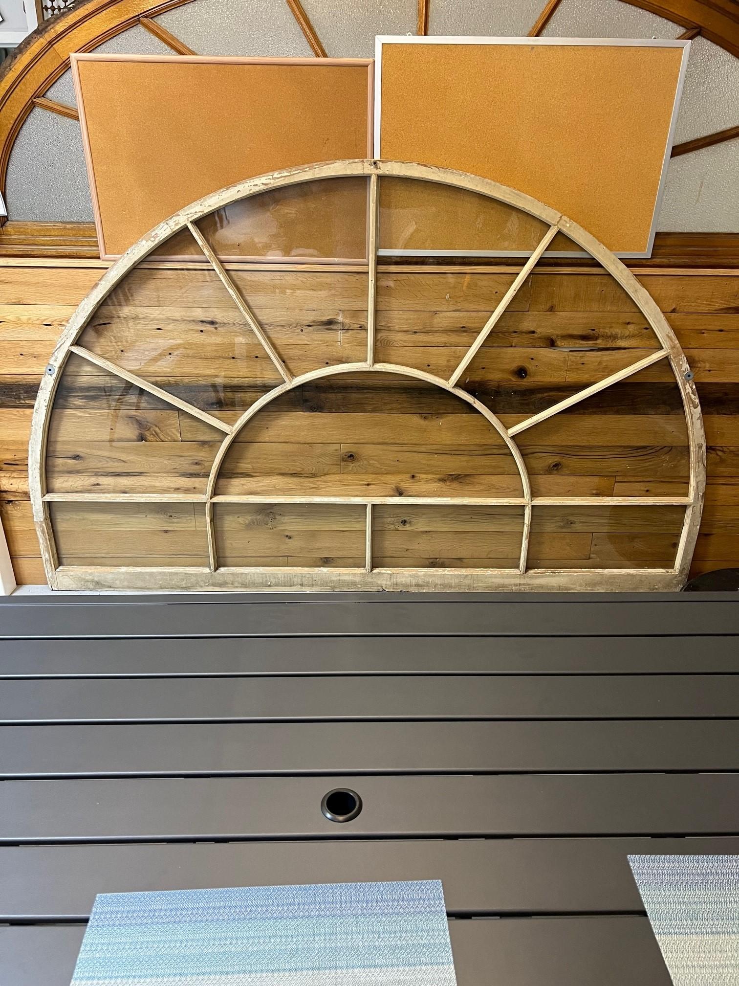 Antique very large arched transom window with original glass in a wood frame. Salvaged from a large estate on the Stamford-Greenwich Ct. border. This is the last one of nine windows salvaged from the estate built in the early 1900s. The window is a