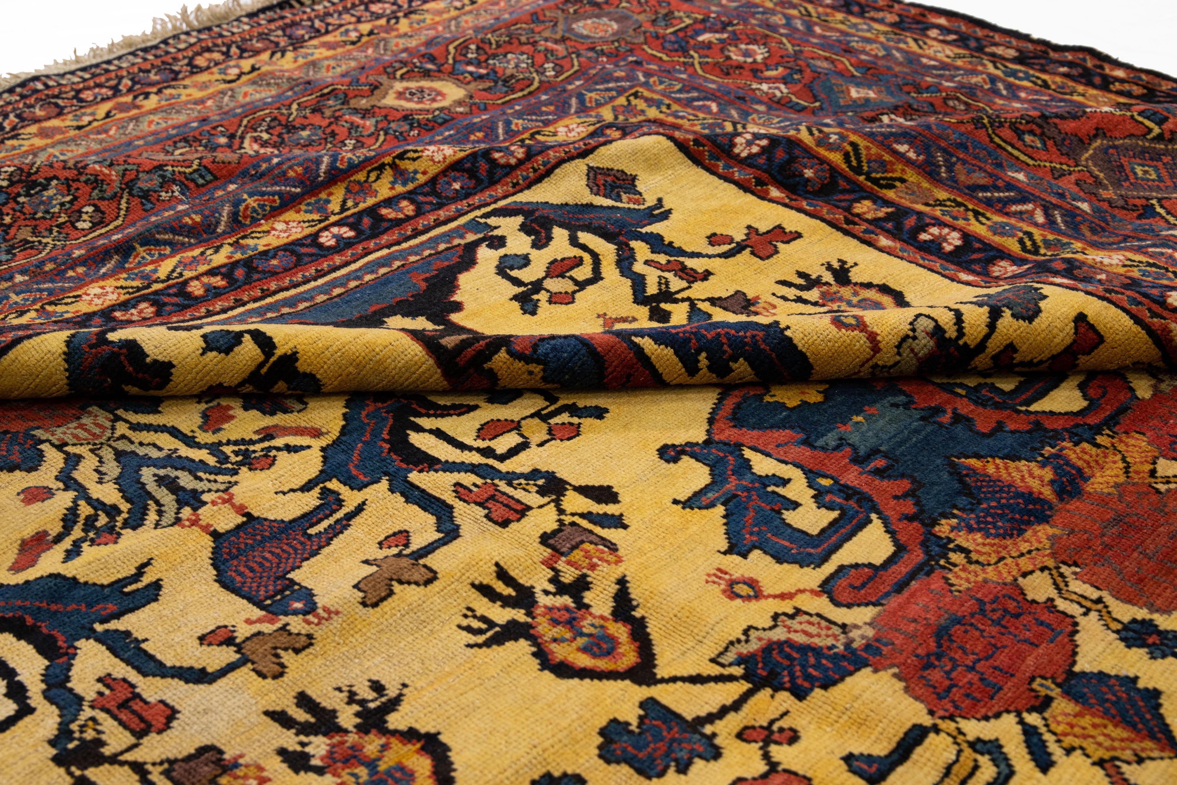 Beautiful antique Bakhtiari hand-knotted wool rug with a yellow field. This piece has a rusted-designed frame with multicolor accents on a gorgeous all-over classic floral design.

This rug measures 13'9