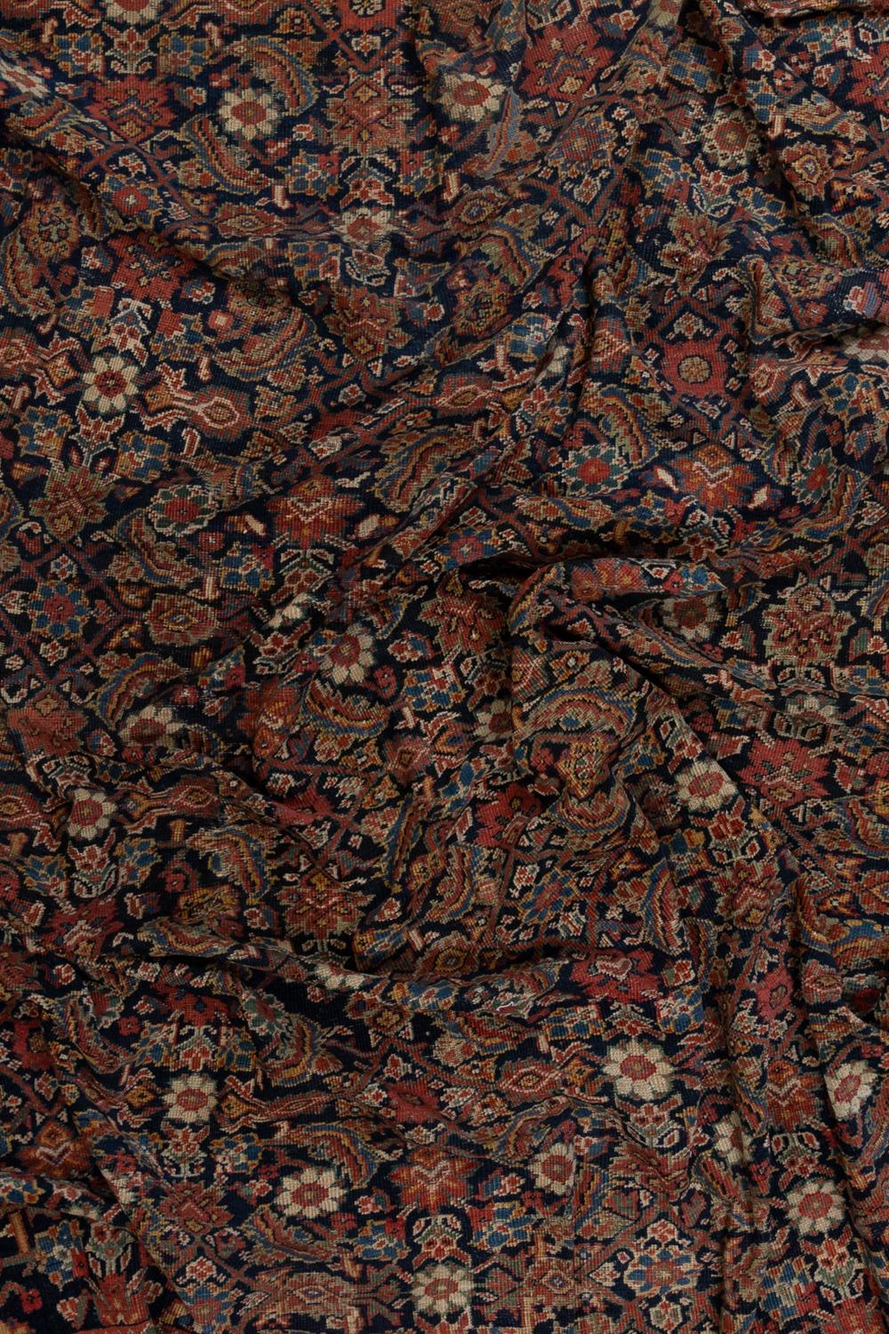 Age: late 19th century 

Pile: medium

Wear Notes: 1

Material: wool on cotton

Rare size and shape, this antique Persian Sultanabad Mahal is almost a square, making it particularly unique in its class. The deep navy field ground the all