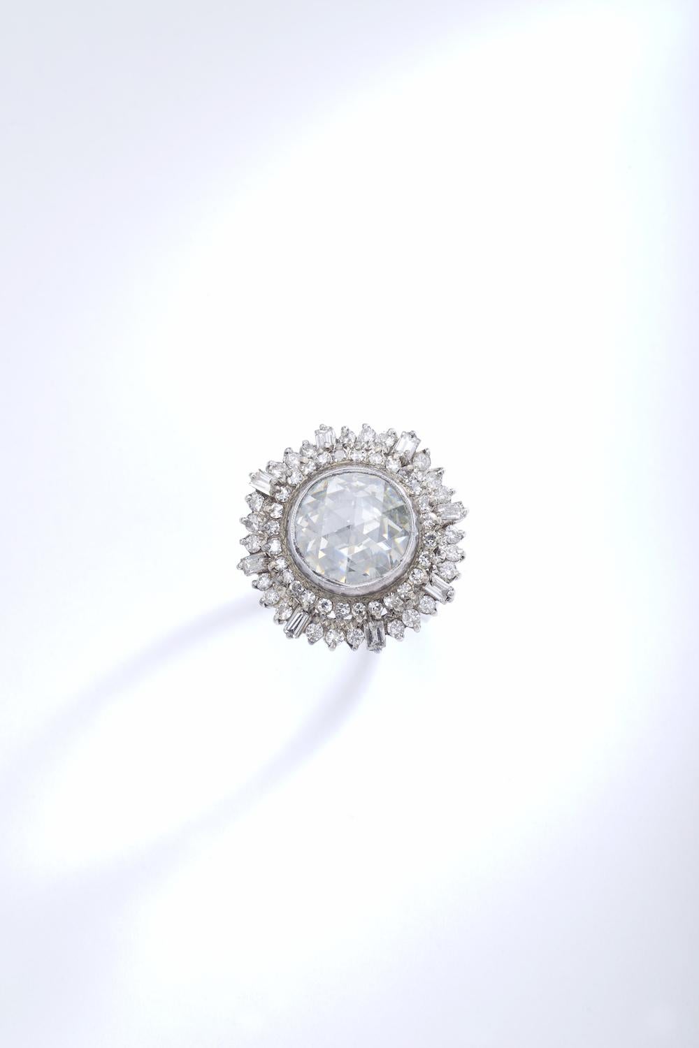 Rare and Collectible! This Antique Rose cut Diamond is clean and white. The mounting is an Indian work with round and baguette cut diamond.
The diameter of the central diamond is approximately 13.50 millimeters. Circa 1950.