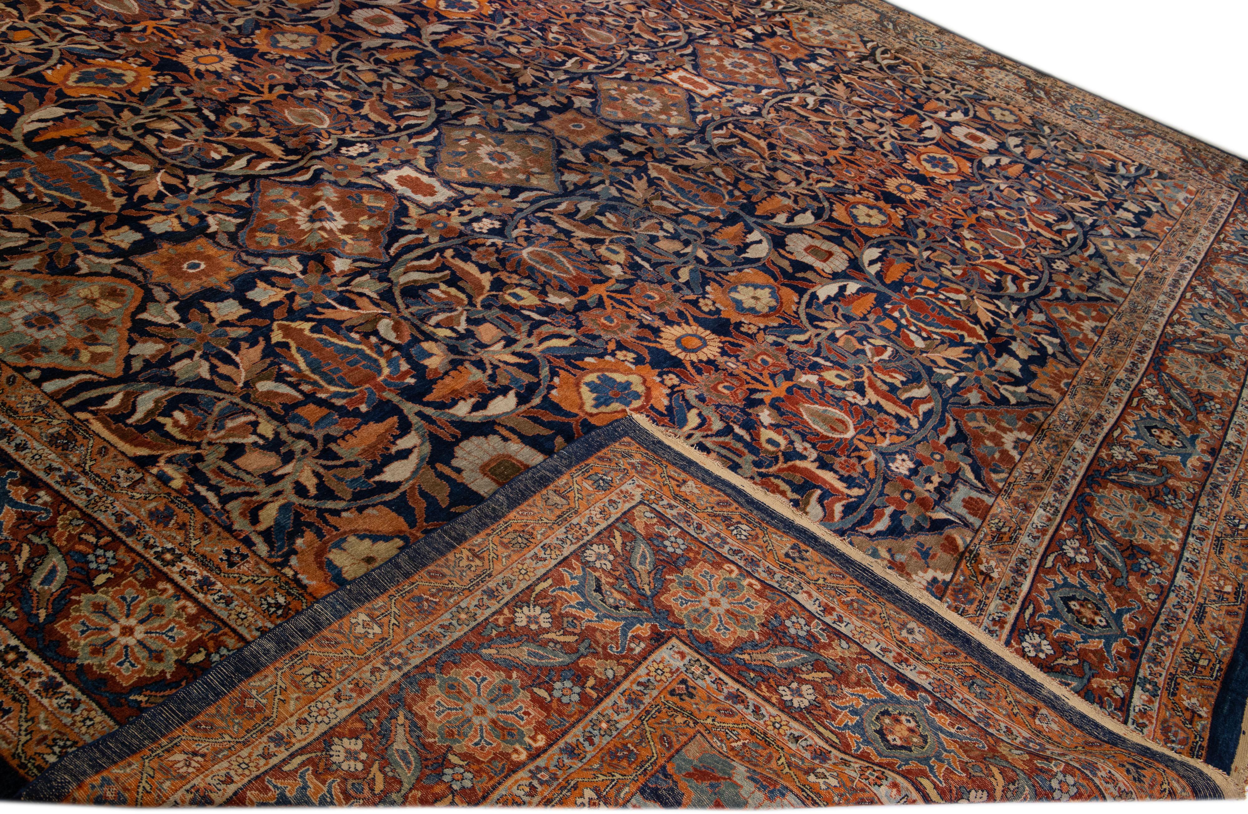 Beautiful antique Persian Sultanabad hand-knotted wool rug with a dark blue field. This piece has a red-orange color-designed frame with multicolor accents in a gorgeous all-over floral pattern design.

This rug measures: 17'3
