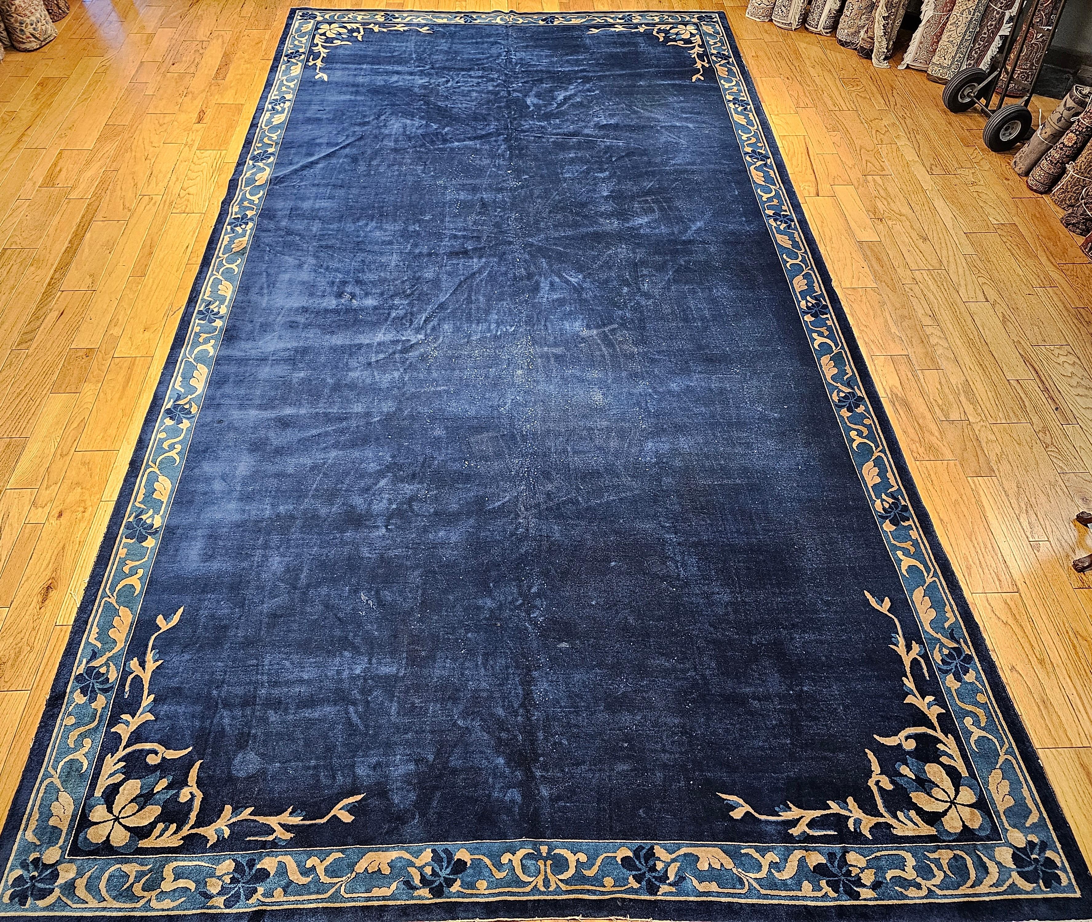 Simple and elegant!  That is how we can best describe the oversize Art Deco Chinese rug from the 1st quarter of the 20th century in an open field design. The rug would bring in elegance through its understatement. The dark blue field is framed by a