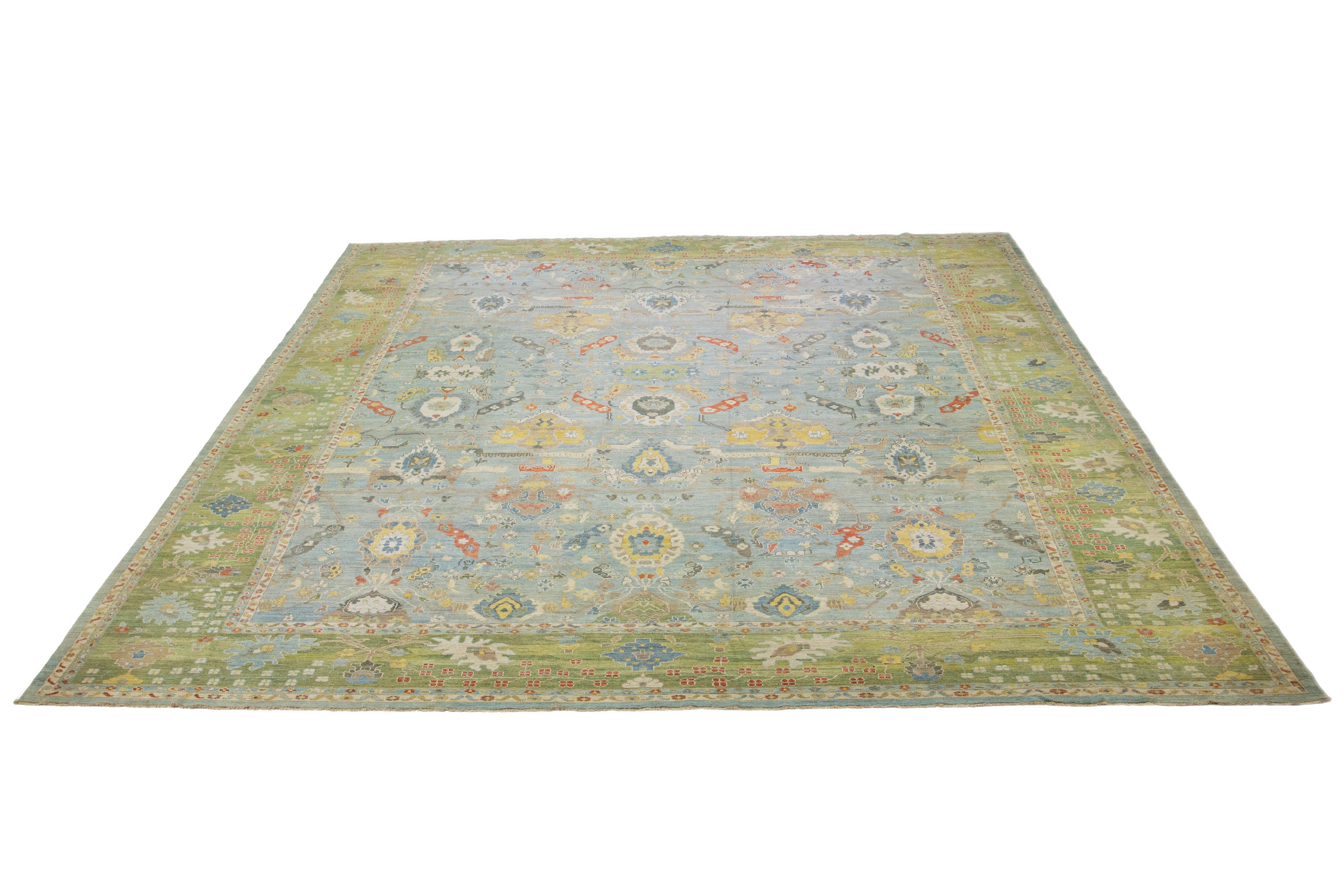 This Sultanabad classic style has been meticulously transformed into a contemporary masterpiece. Crafted with great care, this magnificent wool rug is light blue. Its all-over floral motif is adorned with a green border. To enhance its elegance, it