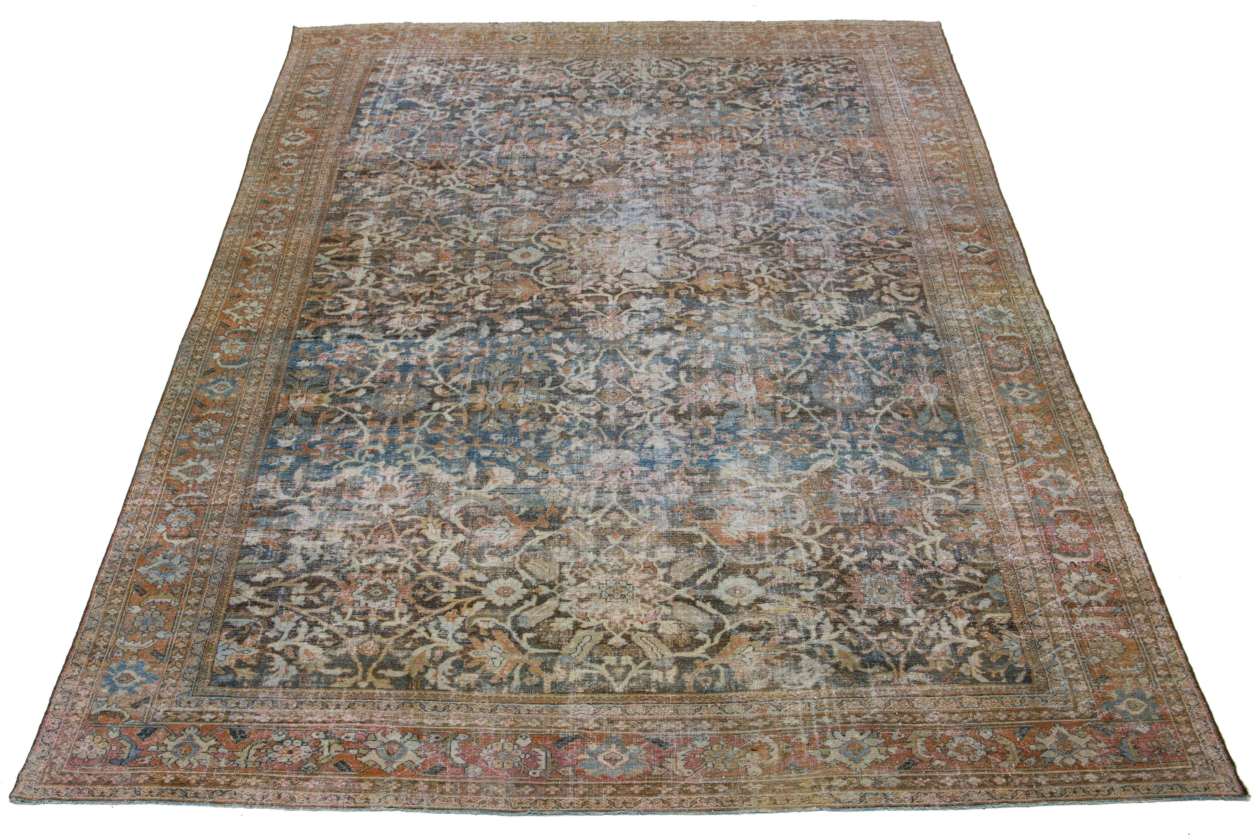 Beautiful antique Persian Mahal hand-knotted wool rug with a beige field. This piece has an orange-designed frame with gray accents in a gorgeous all-over floral design.

This rug measures 13'2