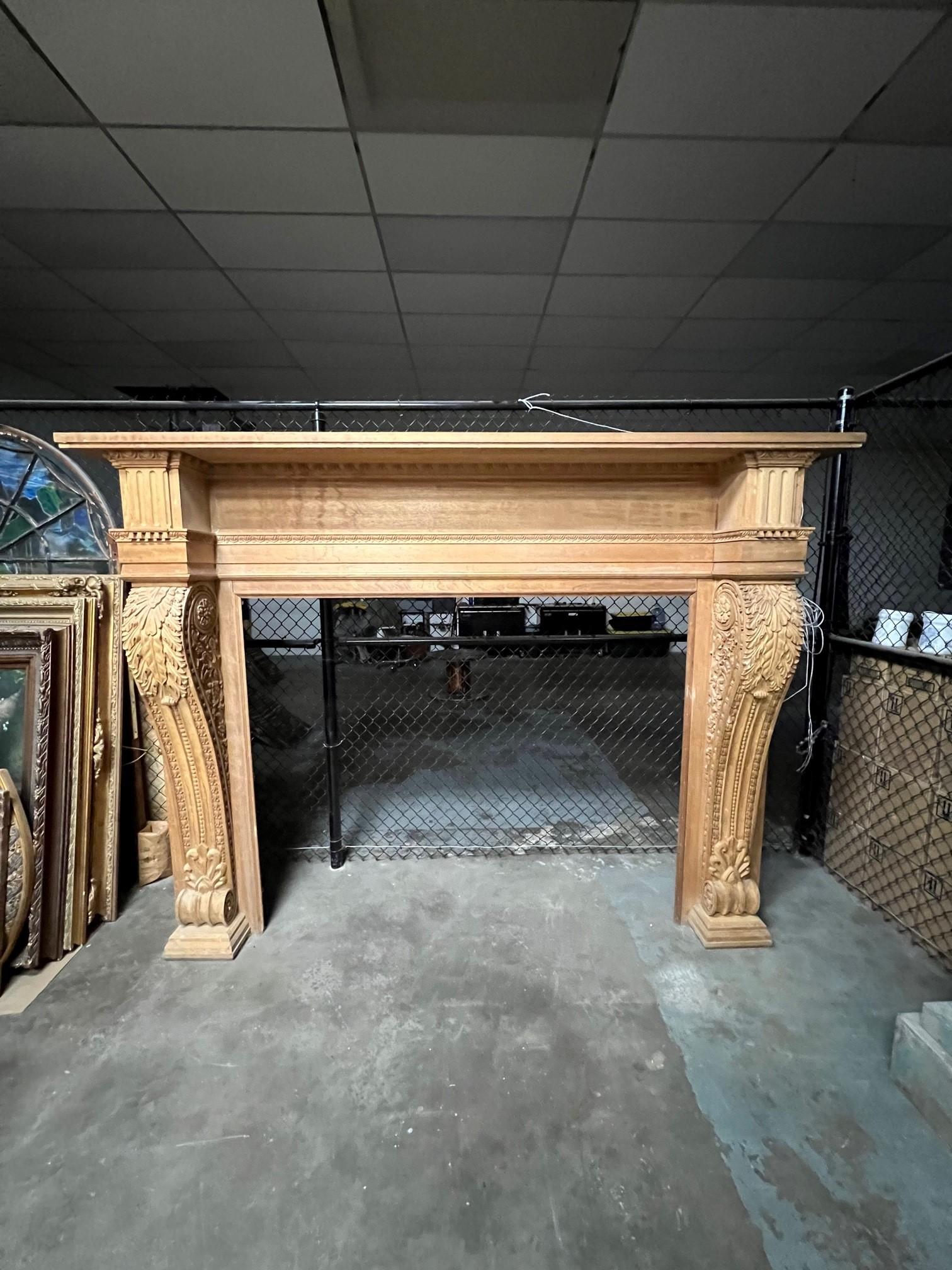 Massive carved wood fireplace mantel with large carved acanthus leaf corbels on each leg. This is a great oversize fireplace mantel that was reproduced from an original mantel dating back to the late 1800s. The mantel has never been installed and is
