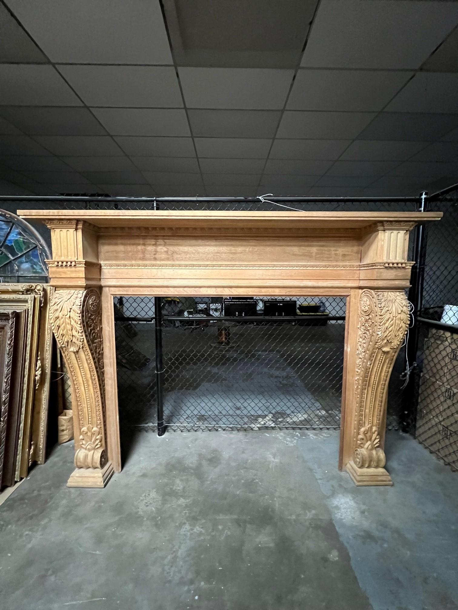Massive carved wood fireplace mantel with large carved acanthus leaf corbels on each leg. This is a great oversize fireplace mantel that was reproduced from an original mantel dating back to the late 1800s. The mantel has never been installed and is