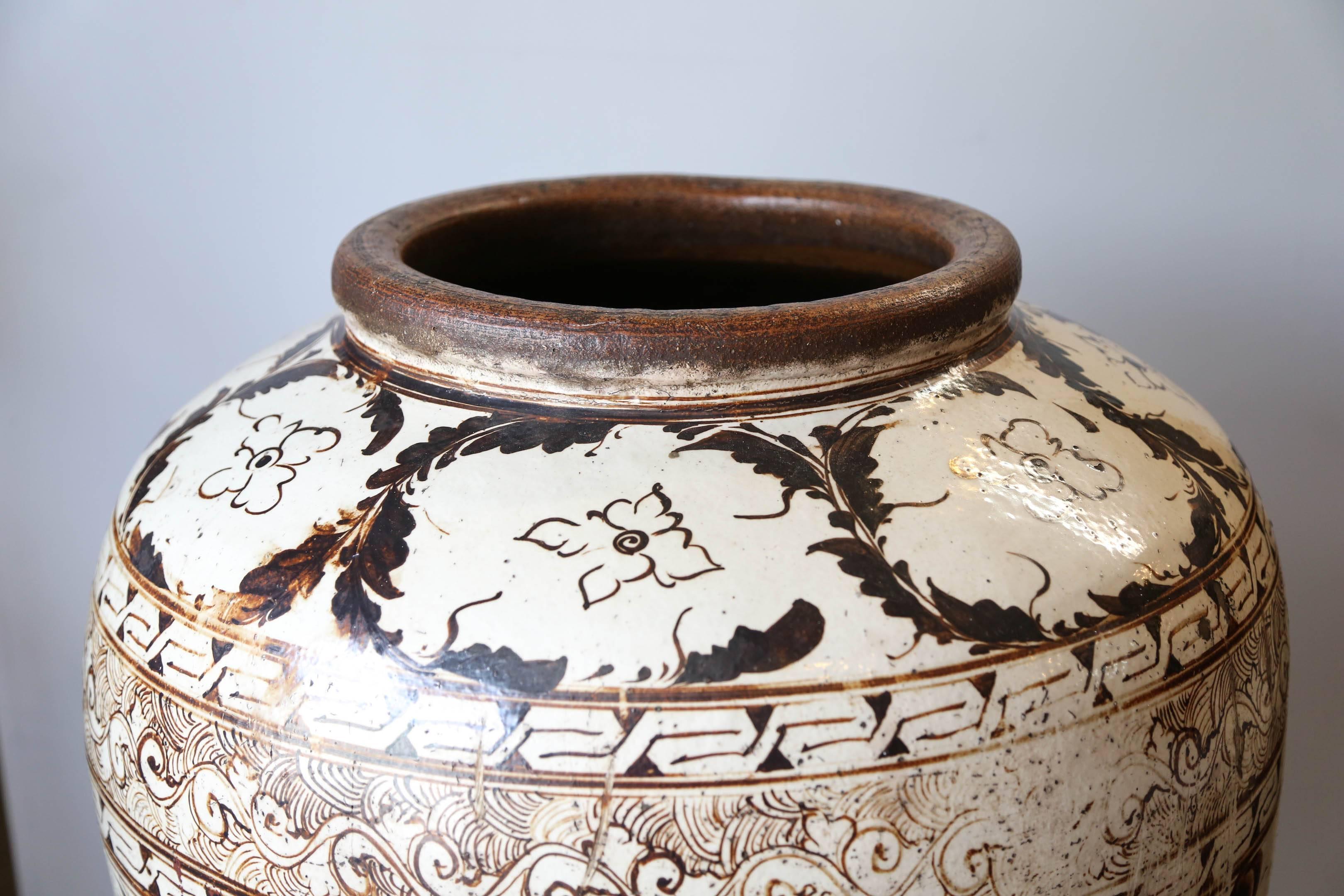 Beautiful very huge Cizhou ware brown painted ceramic jar with leaves and flowers decor. A wave band below the neck. Good condition.
A very comparable but slightly smaller jar in the Metropolitan Museum collection under the accession number